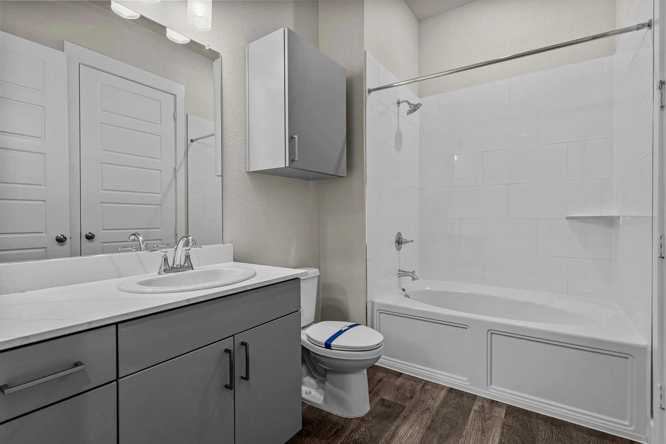 Bright modern bathroom featuring sleek white fixtures, elegant vanity, and luxurious bathtub, ideal for relaxation.