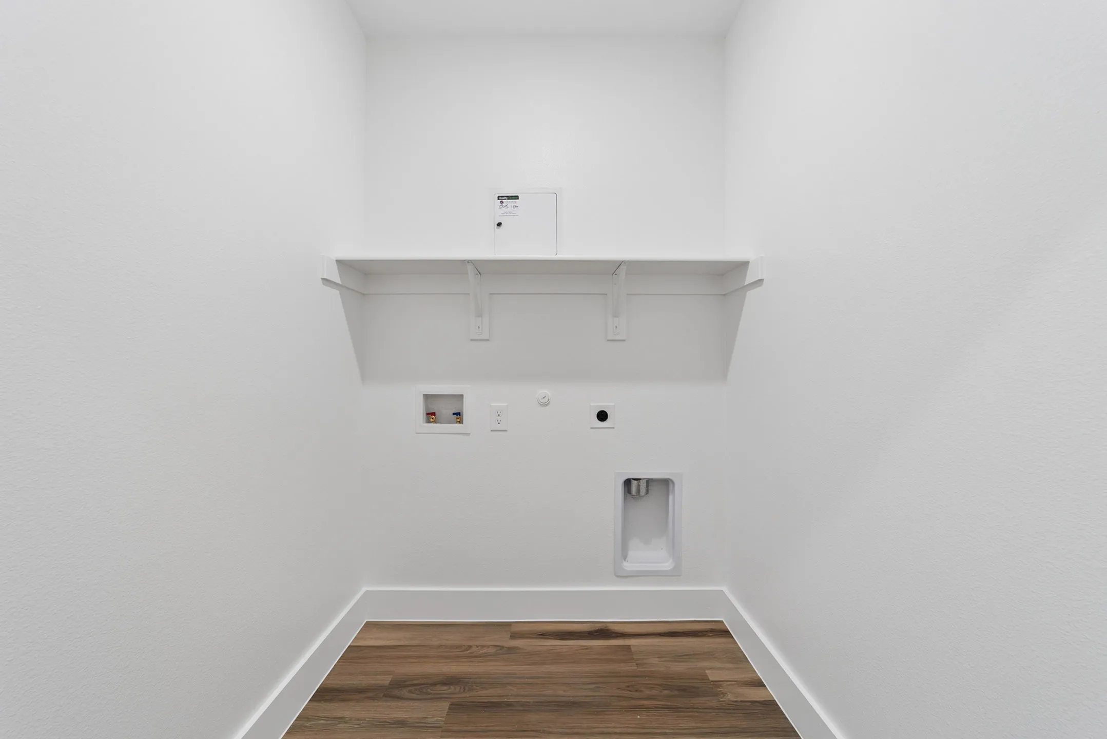 Chic laundry room with modern utilities and elegant wood flooring.