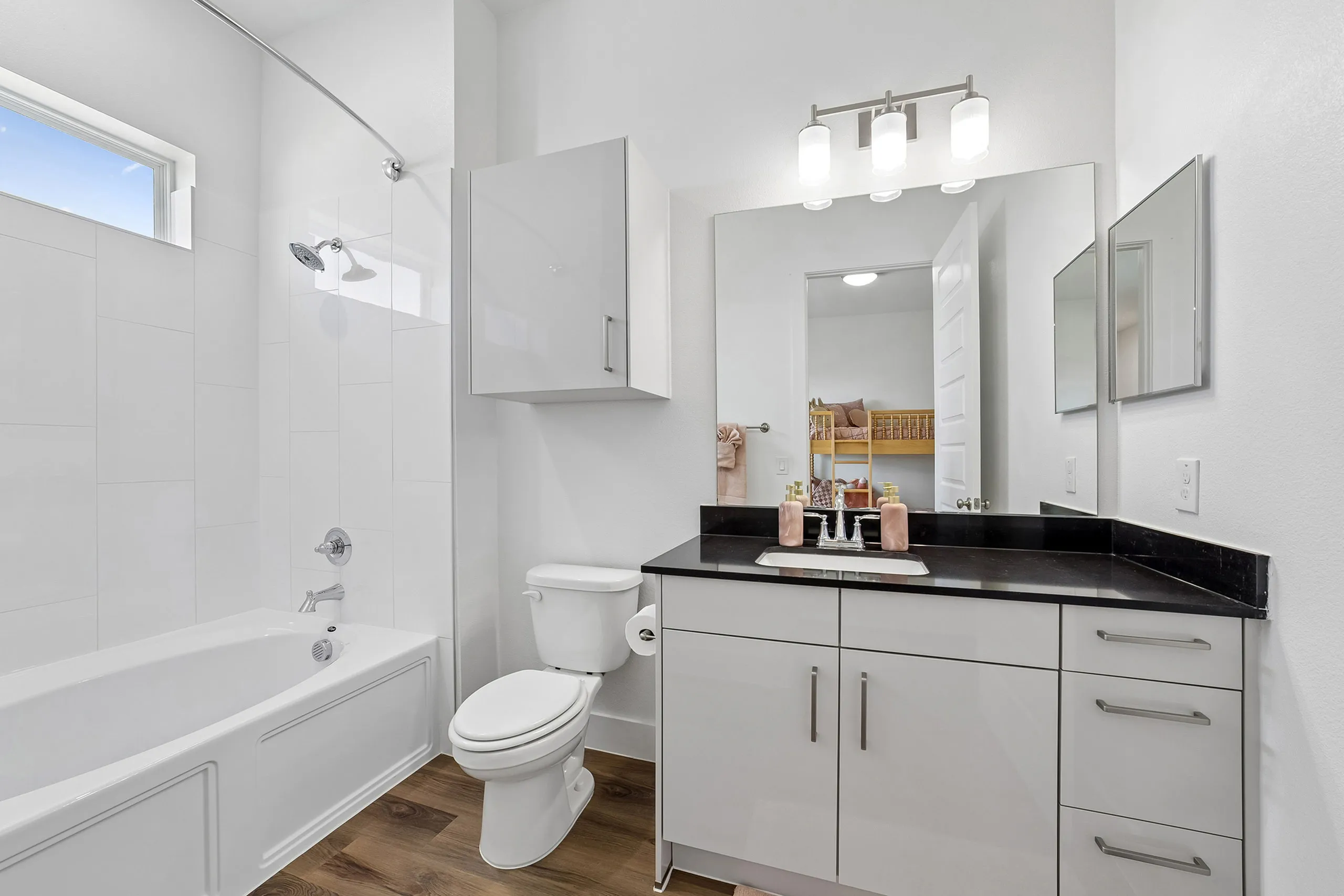 Modern bathroom showcasing sleek design with a white bathtub, contemporary vanity, and bright lighting for a fresh, inviting look.