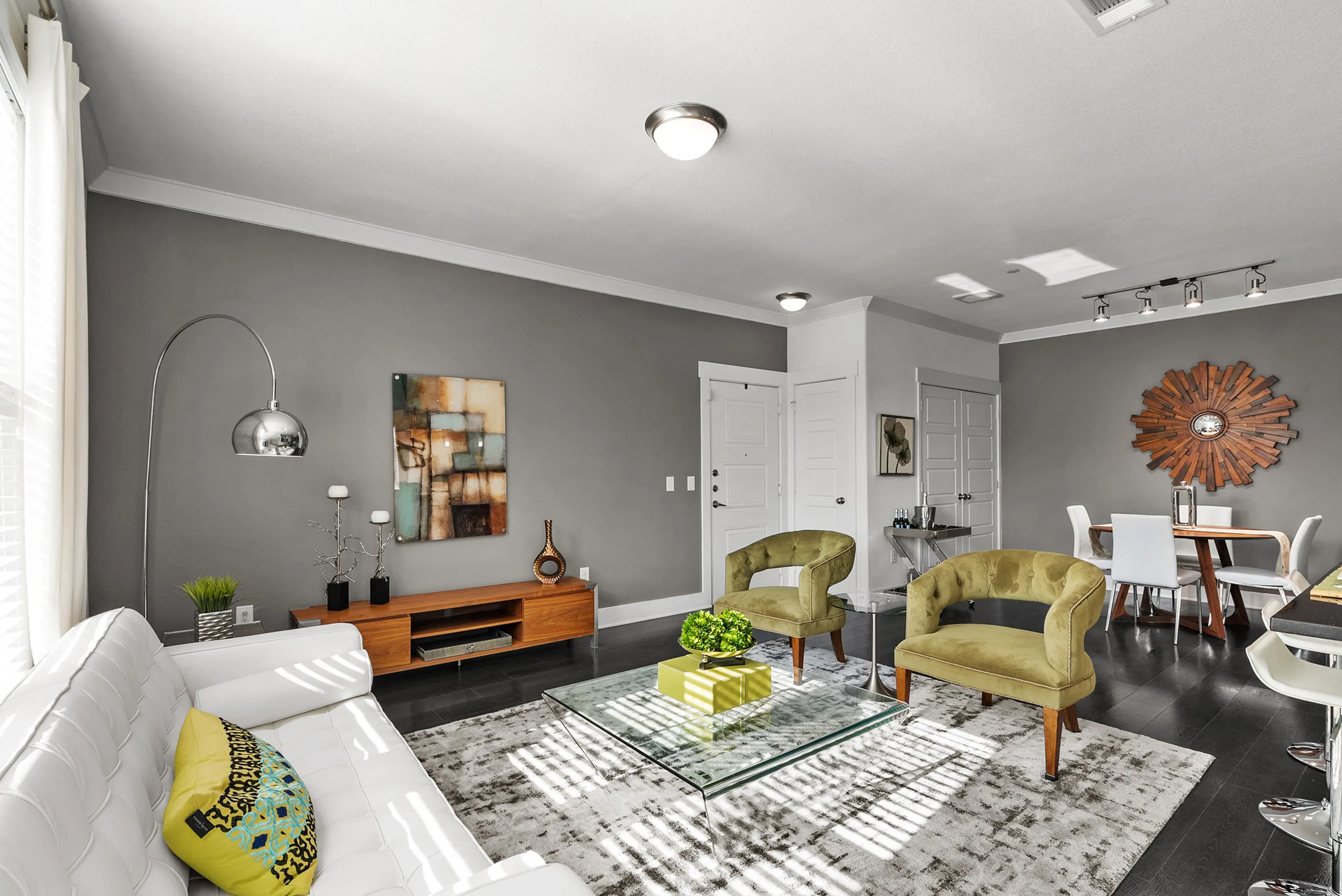 Modern and stylish living room featuring sleek furniture, contemporary wall art, and abundant natural light, creating a warm and inviting space.