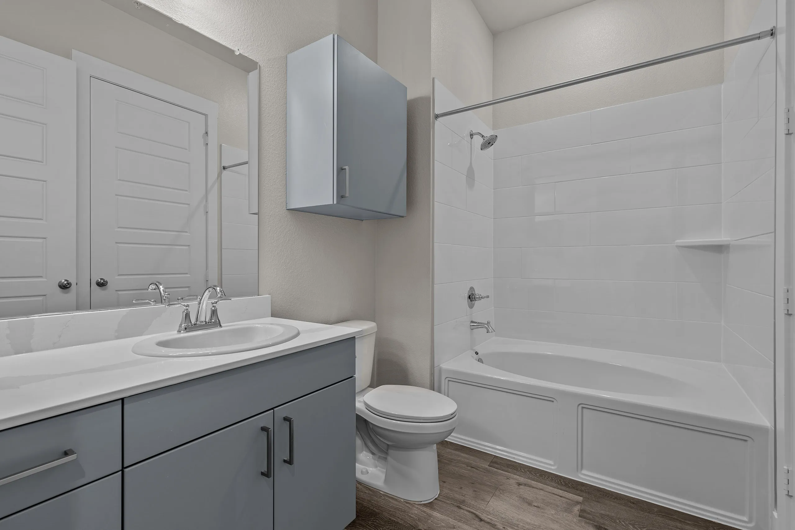 Elegant bathroom featuring sleek cabinetry, modern fixtures, and a pristine shower-bath combo.