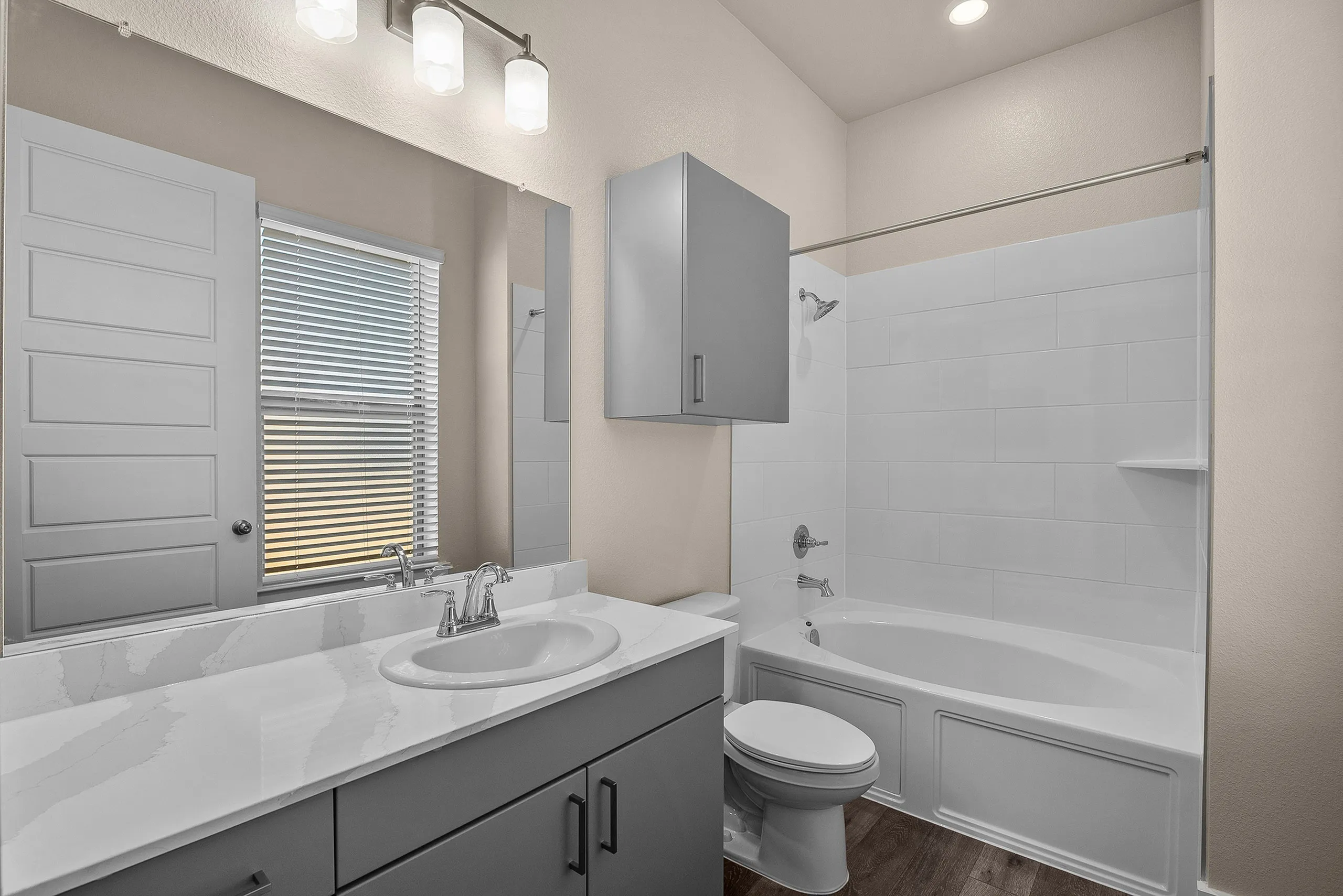 Elegant bathroom with modern fixtures, featuring a sleek vanity, bathtub, and stylish lighting.