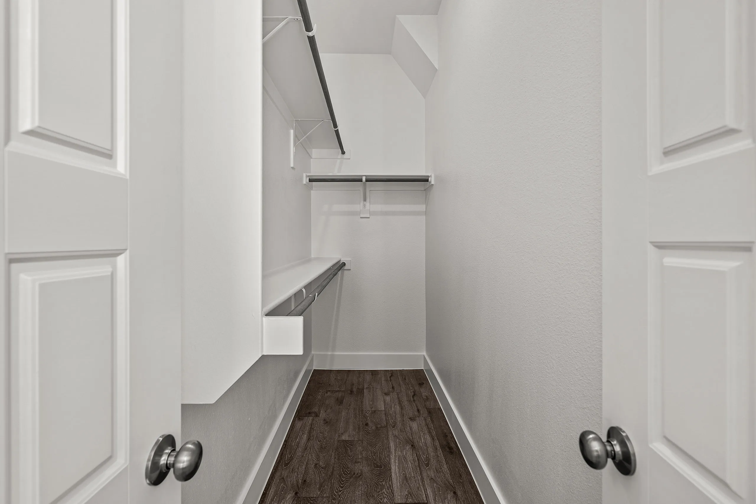 Elegant walk-in closet with ample storage space and sleek shelving, perfect for organization and style.