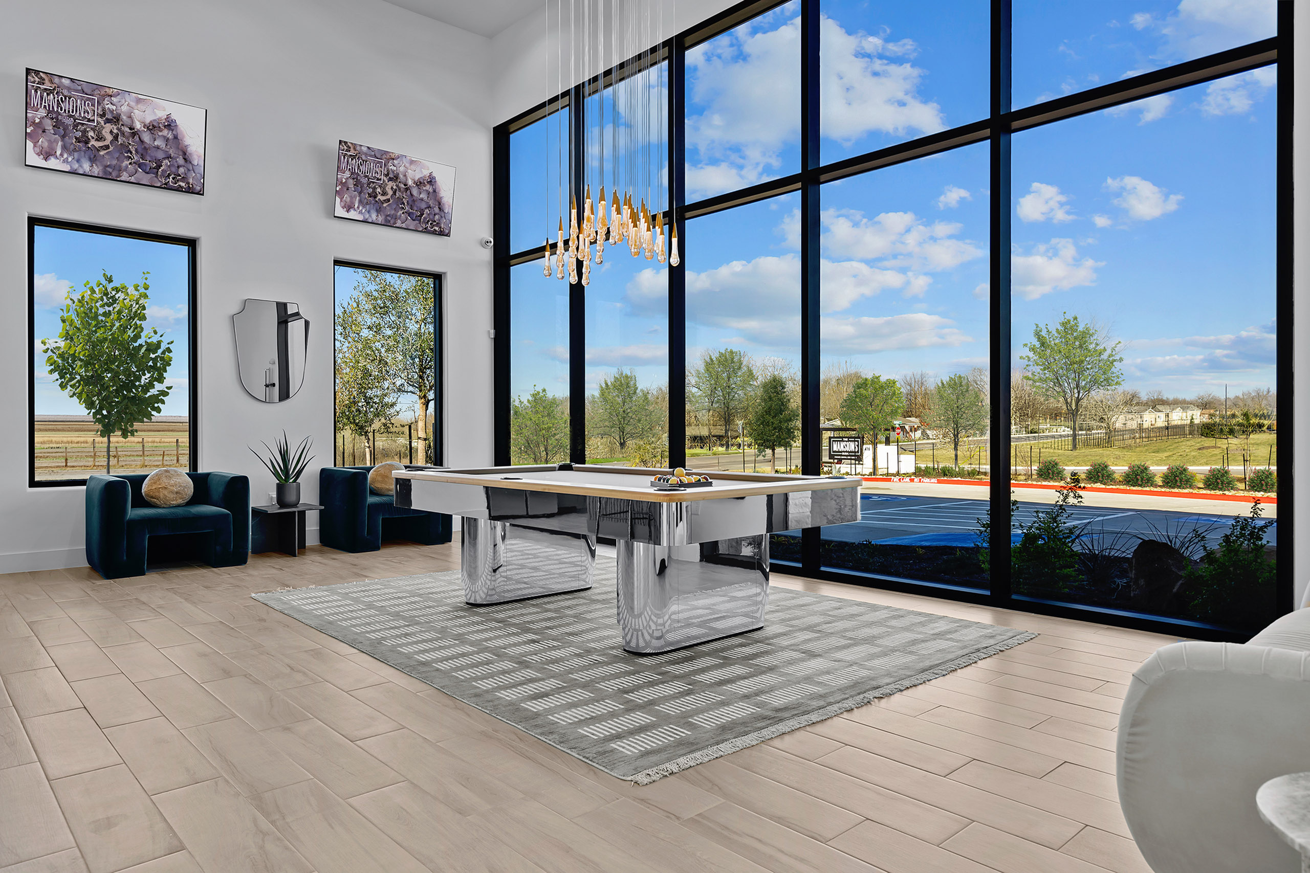Bright and modern game room with elegant billiard table, floor-to-ceiling windows, and captivating scenic views.