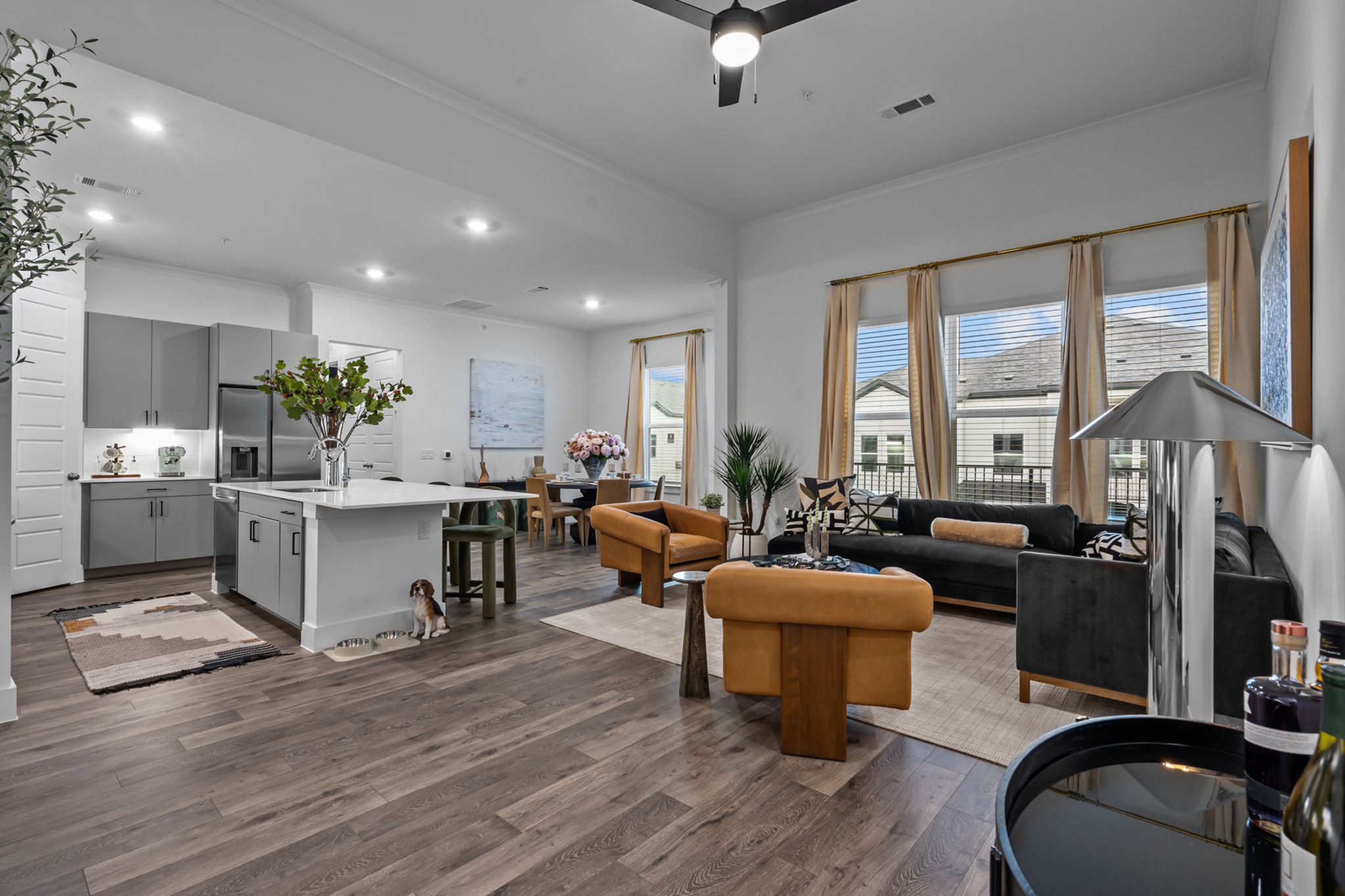 Elegant open-plan living space with modern kitchen, stylish seating area, and abundant natural light, perfect for luxury living.
