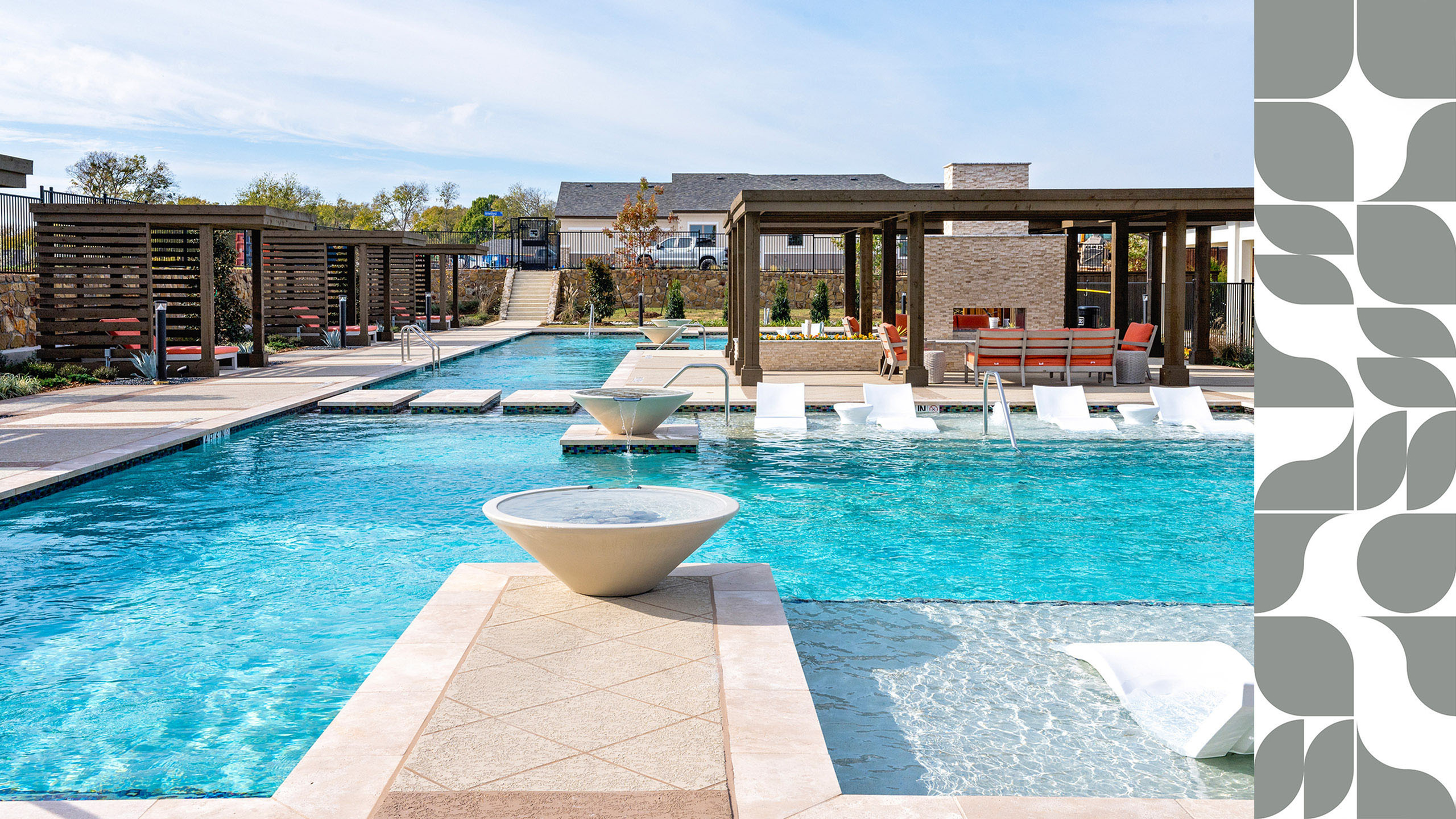 Elegant outdoor pool area with modern loungers and shaded pergolas, surrounded by lush landscaping.