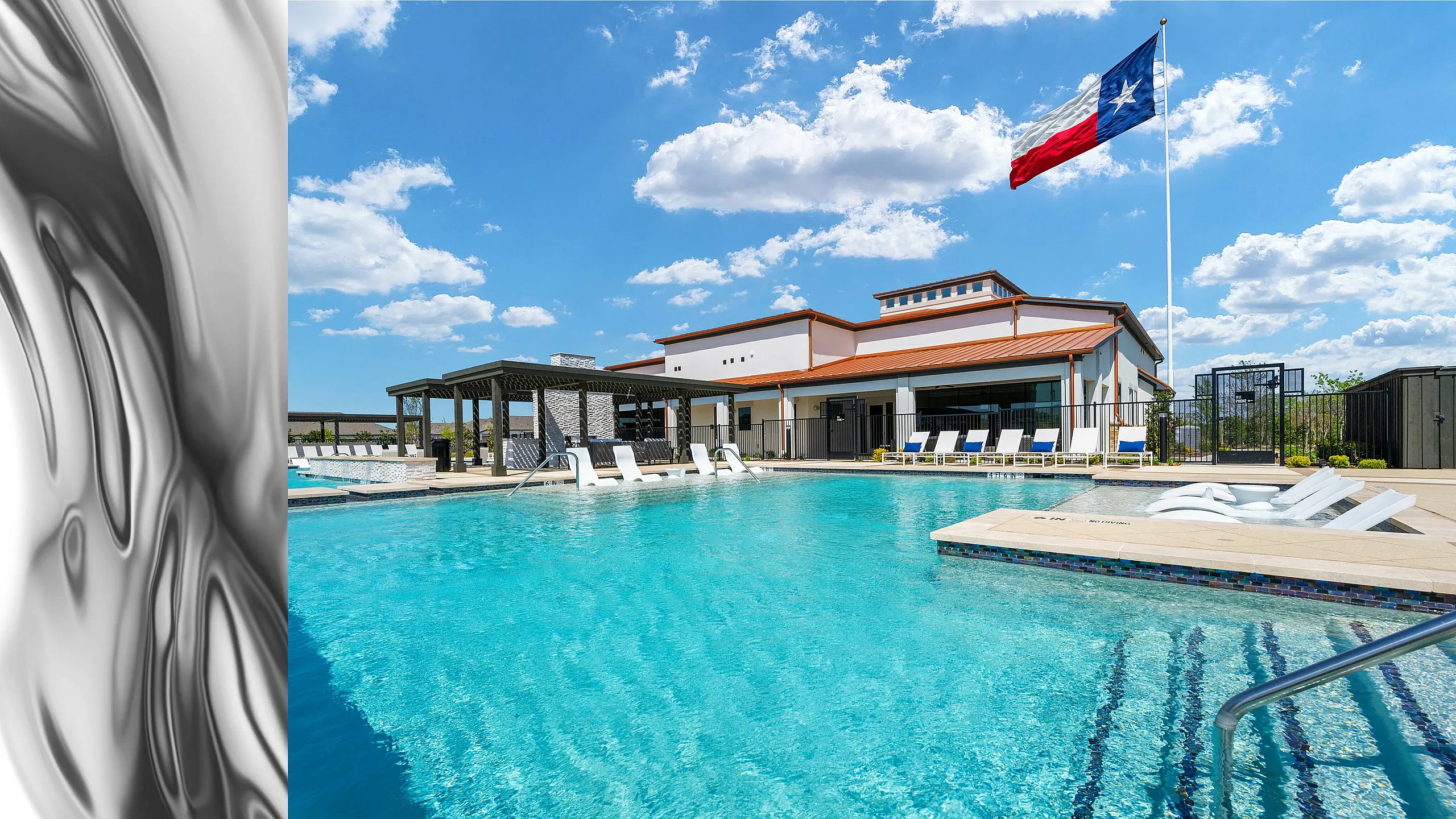 Inviting outdoor pool with lounge chairs and shaded areas, flag waving under a clear blue sky.
