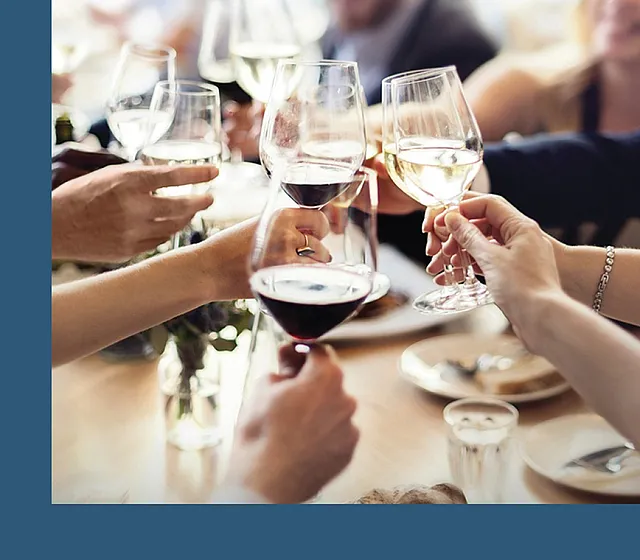 Vibrant social gathering with friends toasting with an elegant selection of red and white wines.