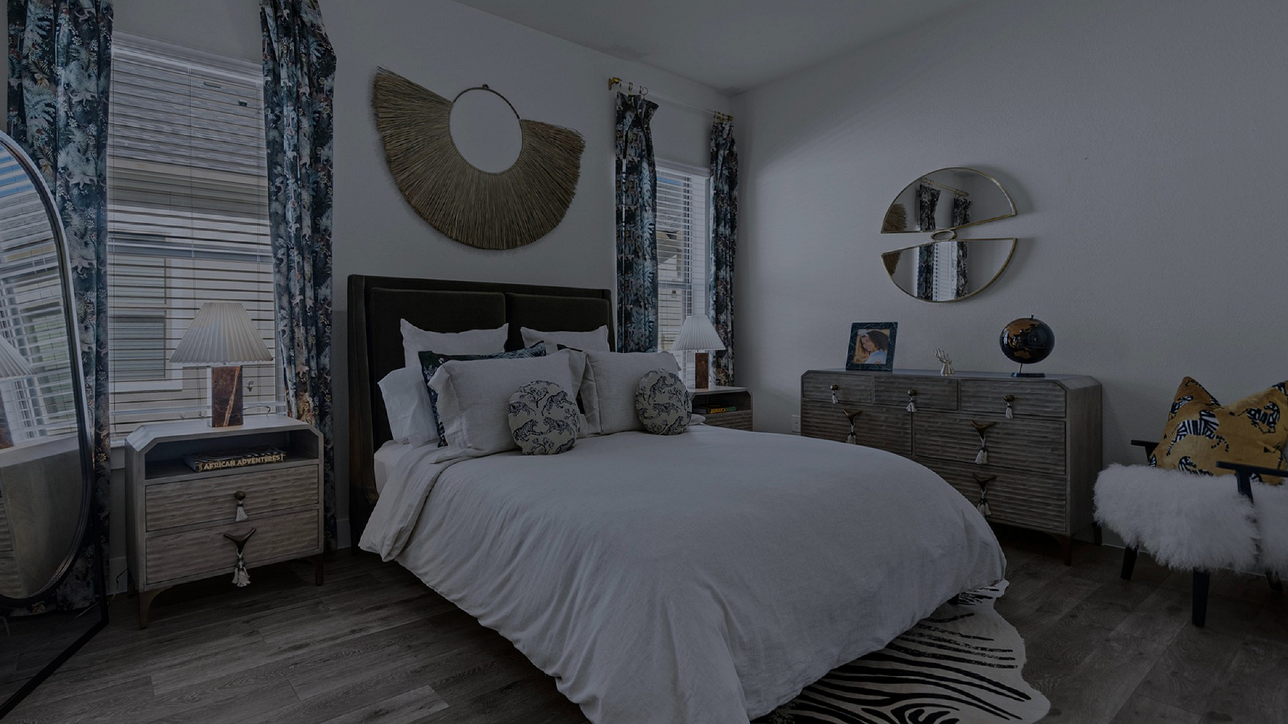 Elegant bedroom with chic decor, featuring a plush bed, stylish nightstands, and vibrant curtains creating a cozy ambiance.