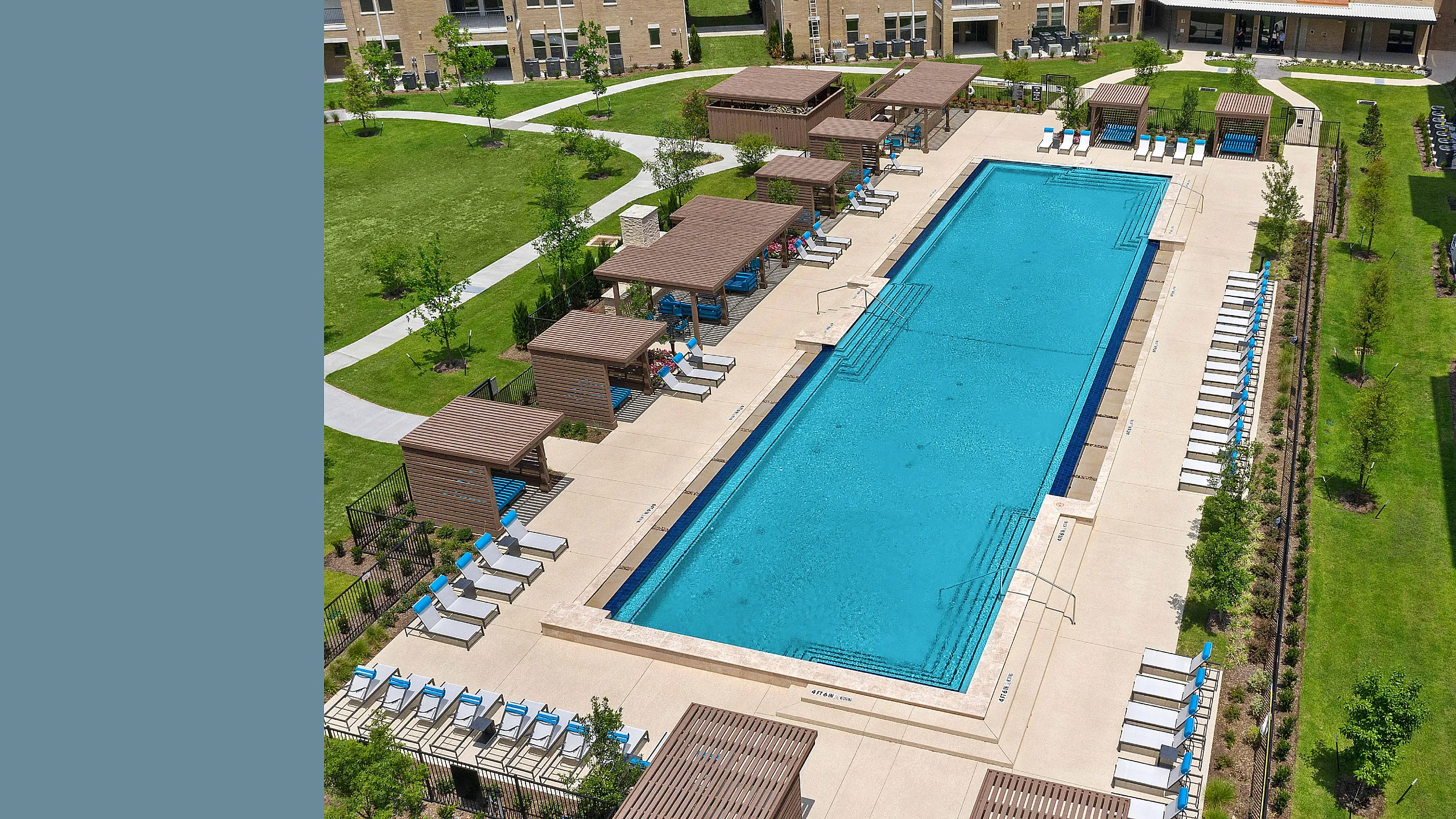 Elegant community pool surrounded by lush greenery, stylish cabanas, and ample lounge chairs, perfect for relaxation and leisure.