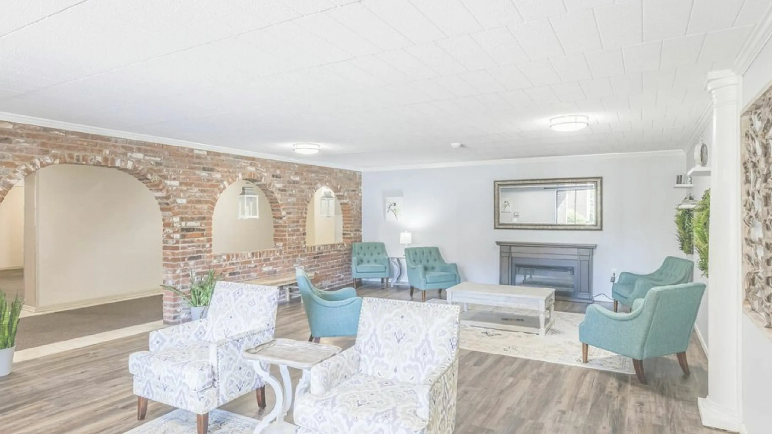 Bright and stylish living room with vintage brick arches, cozy seating, and elegant decor.