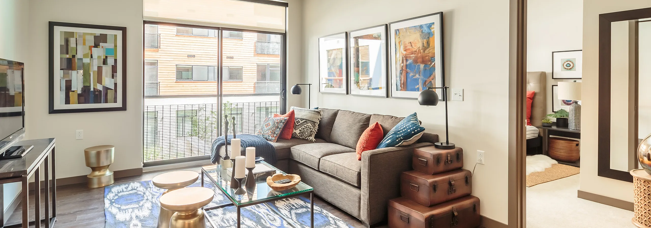 Bright and stylish living room featuring a modern sofa, chic decor, and large windows providing natural light.