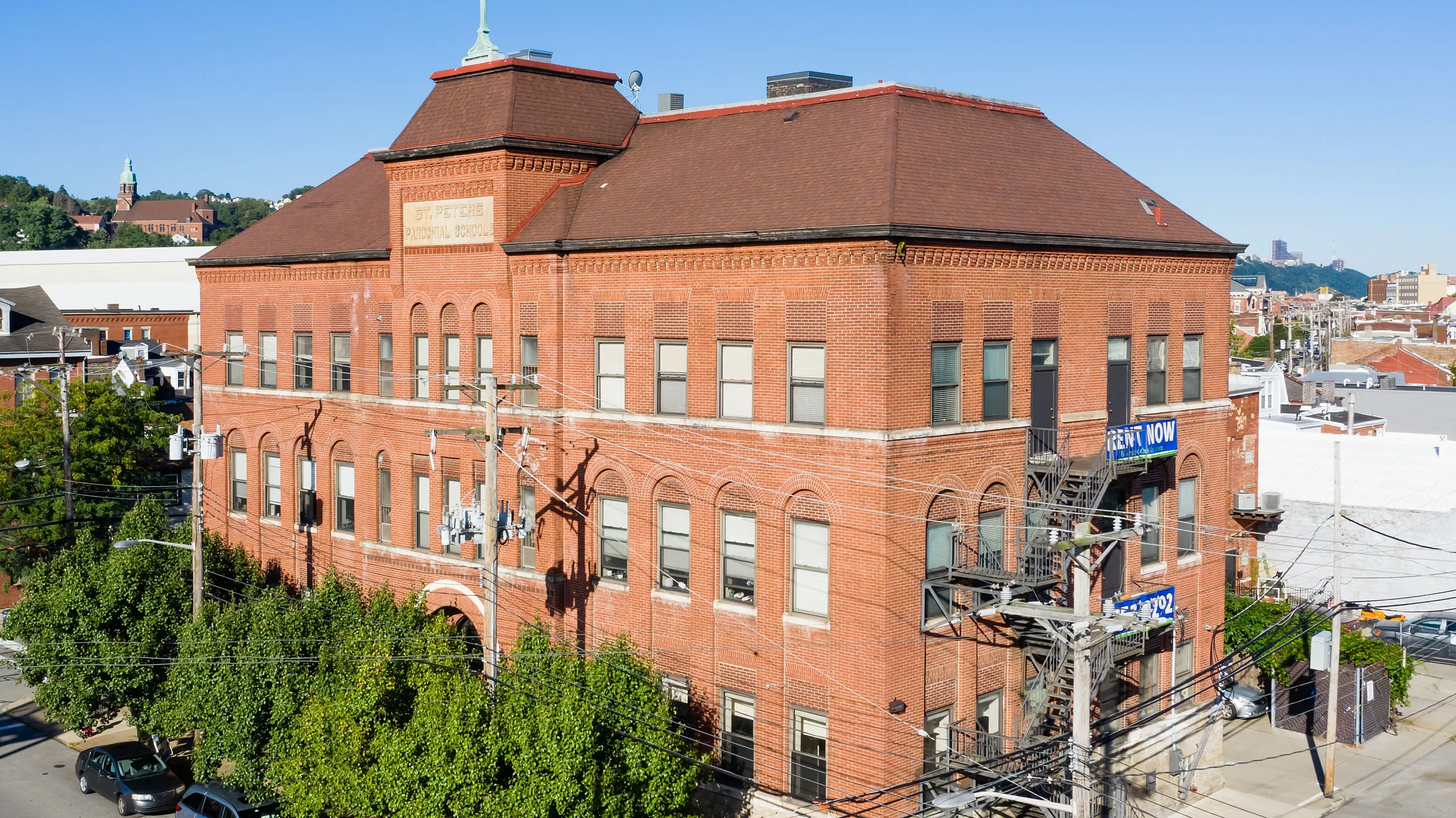 Charming historic red brick building available for rent, featuring classic architecture in a vibrant urban setting.