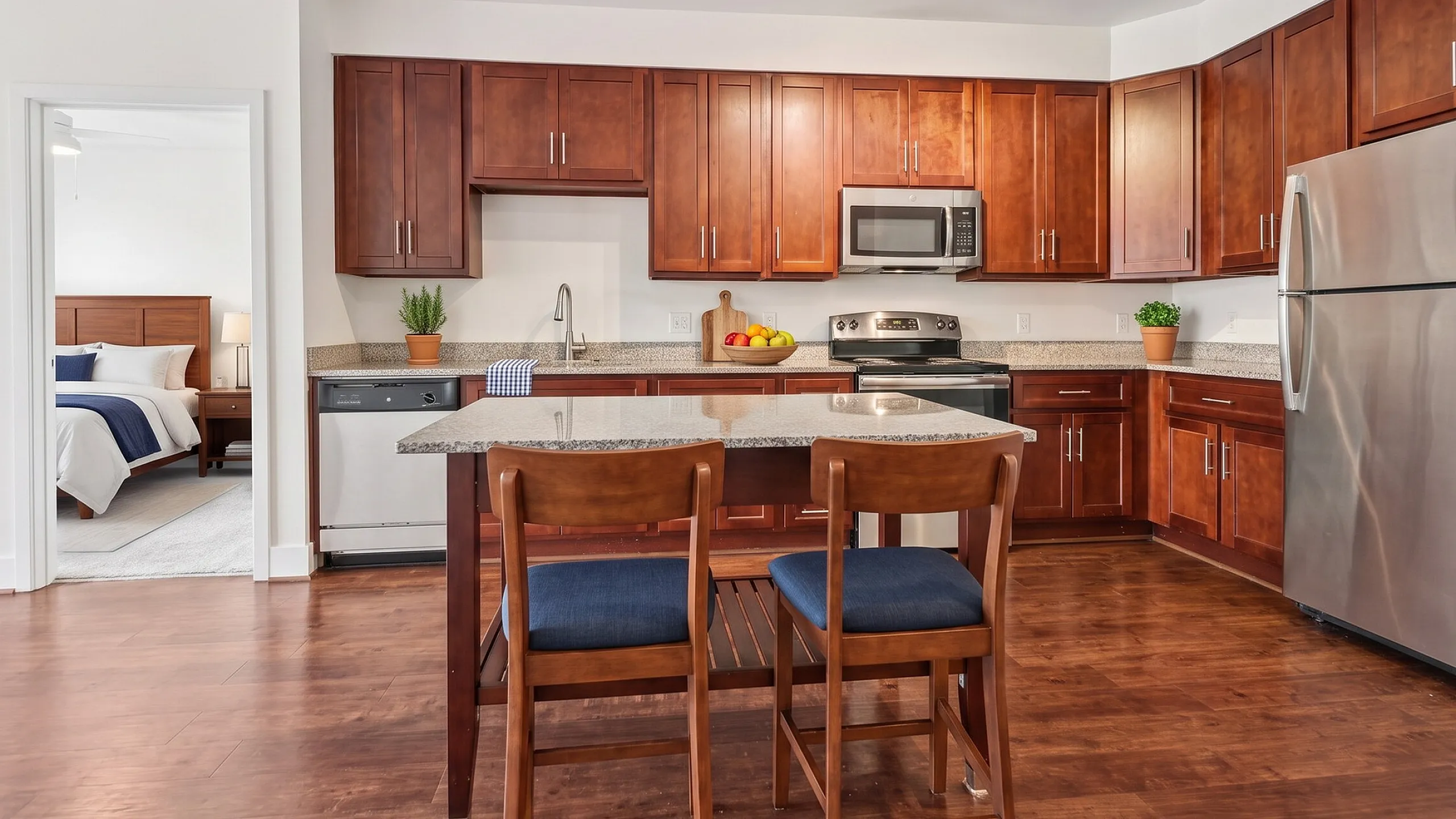 Sleek and modern kitchen with rich wooden cabinets, stainless steel appliances, and a cozy breakfast bar, seamlessly connected to a stylish bedroom.