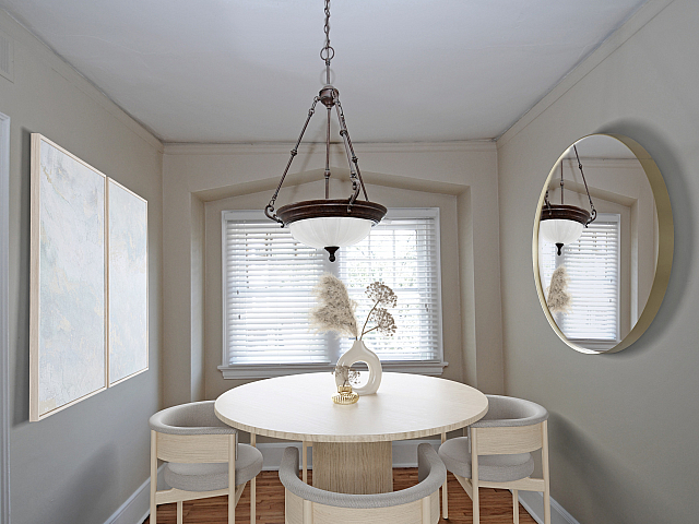 Elegant dining nook with a round table, stylish chairs, decorative centerpiece, and ambient lighting.
