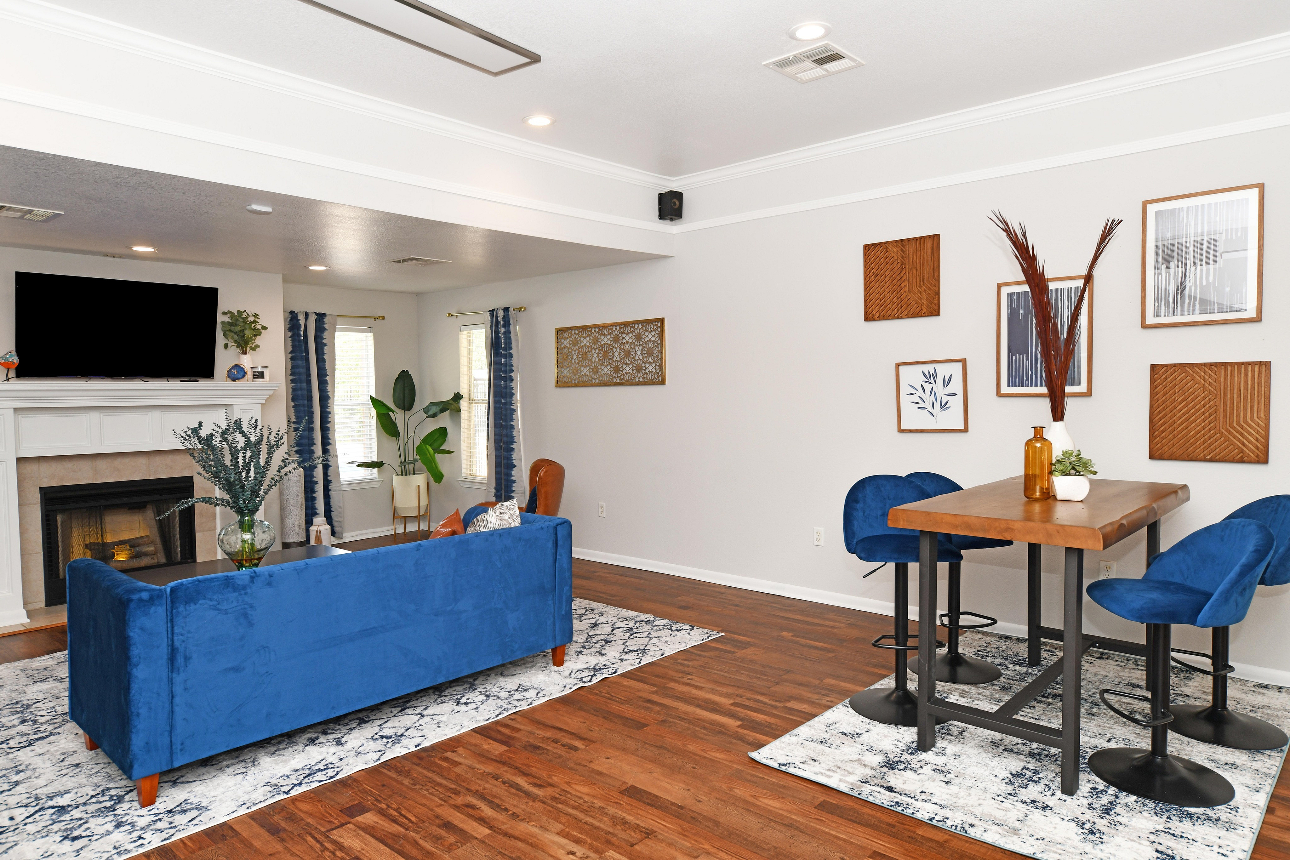 Inviting living room with a plush blue sofa, fireplace, and elegant decor.