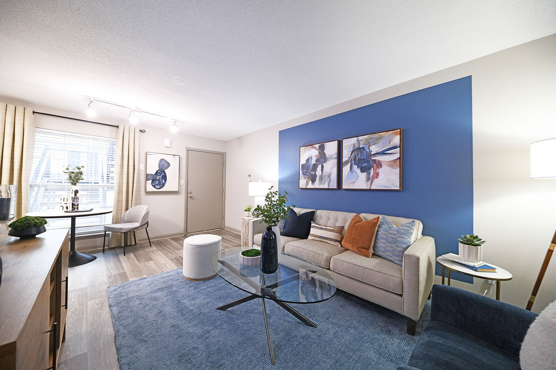 Bright and welcoming living room with modern furniture and a blue accent wall.
