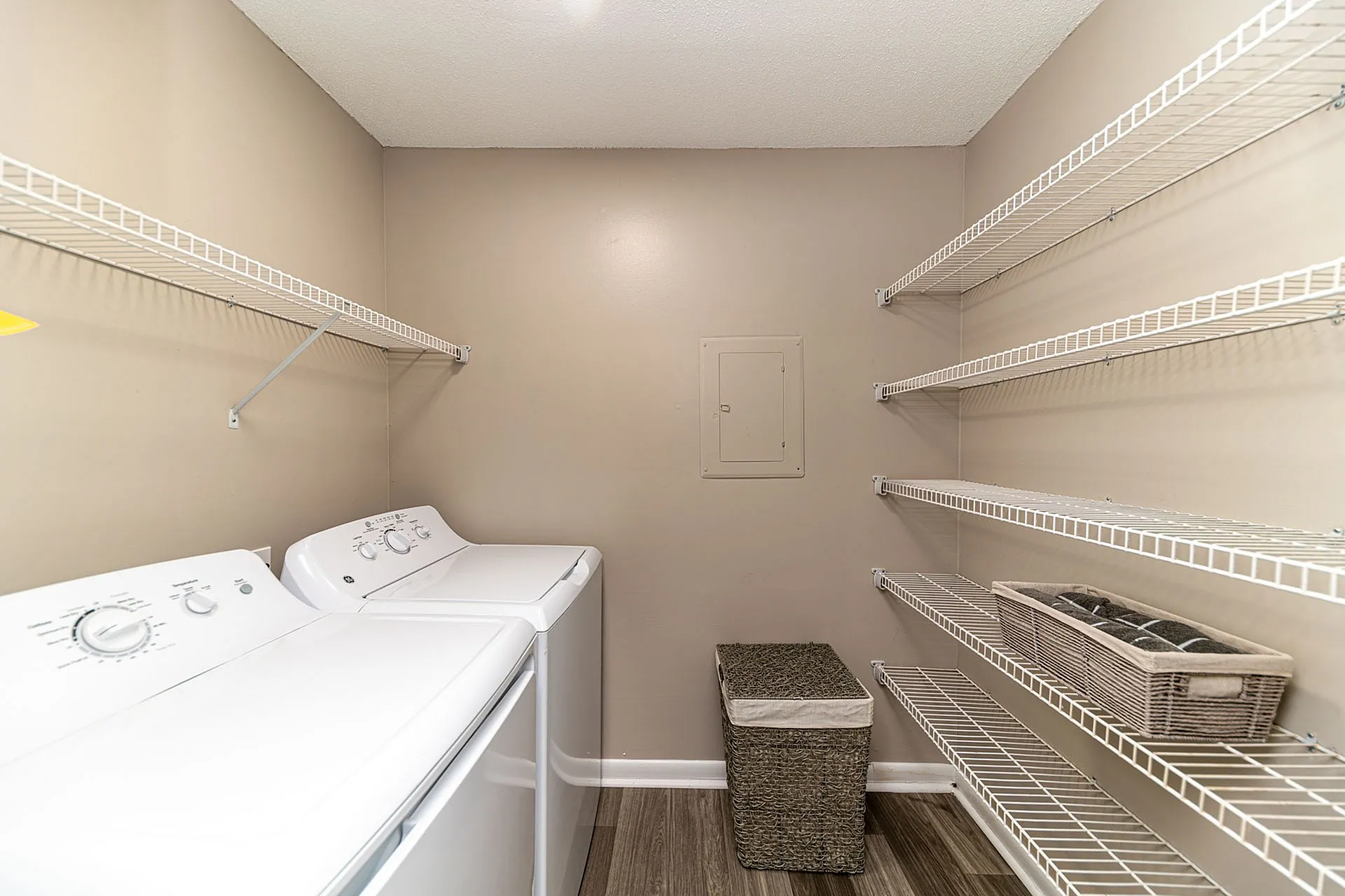 Modern laundry room with energy-efficient washer and dryer alongside ample shelving for convenient storage.