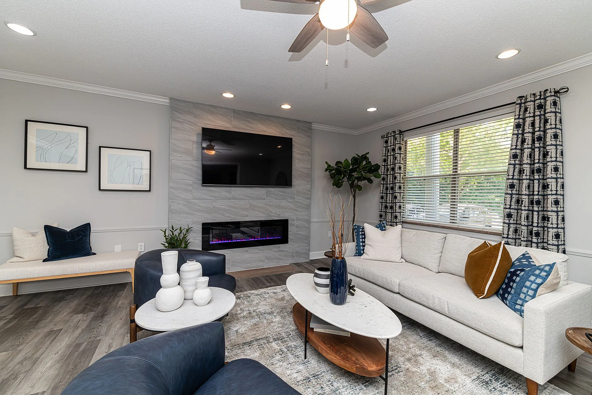 Elegant living room with modern fireplace, plush sofa, and stylish decor, perfect for relaxation and entertaining.