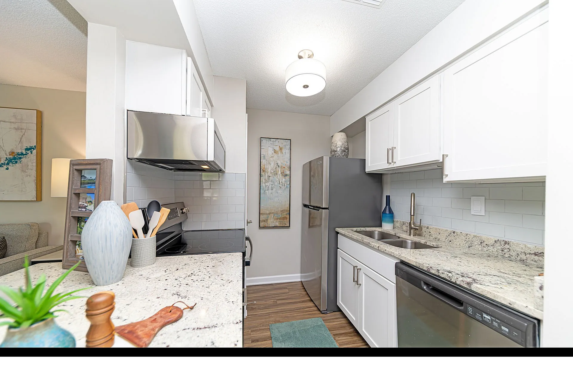 Bright, modern kitchen featuring sleek white cabinetry, stainless steel appliances, and elegant granite countertops.