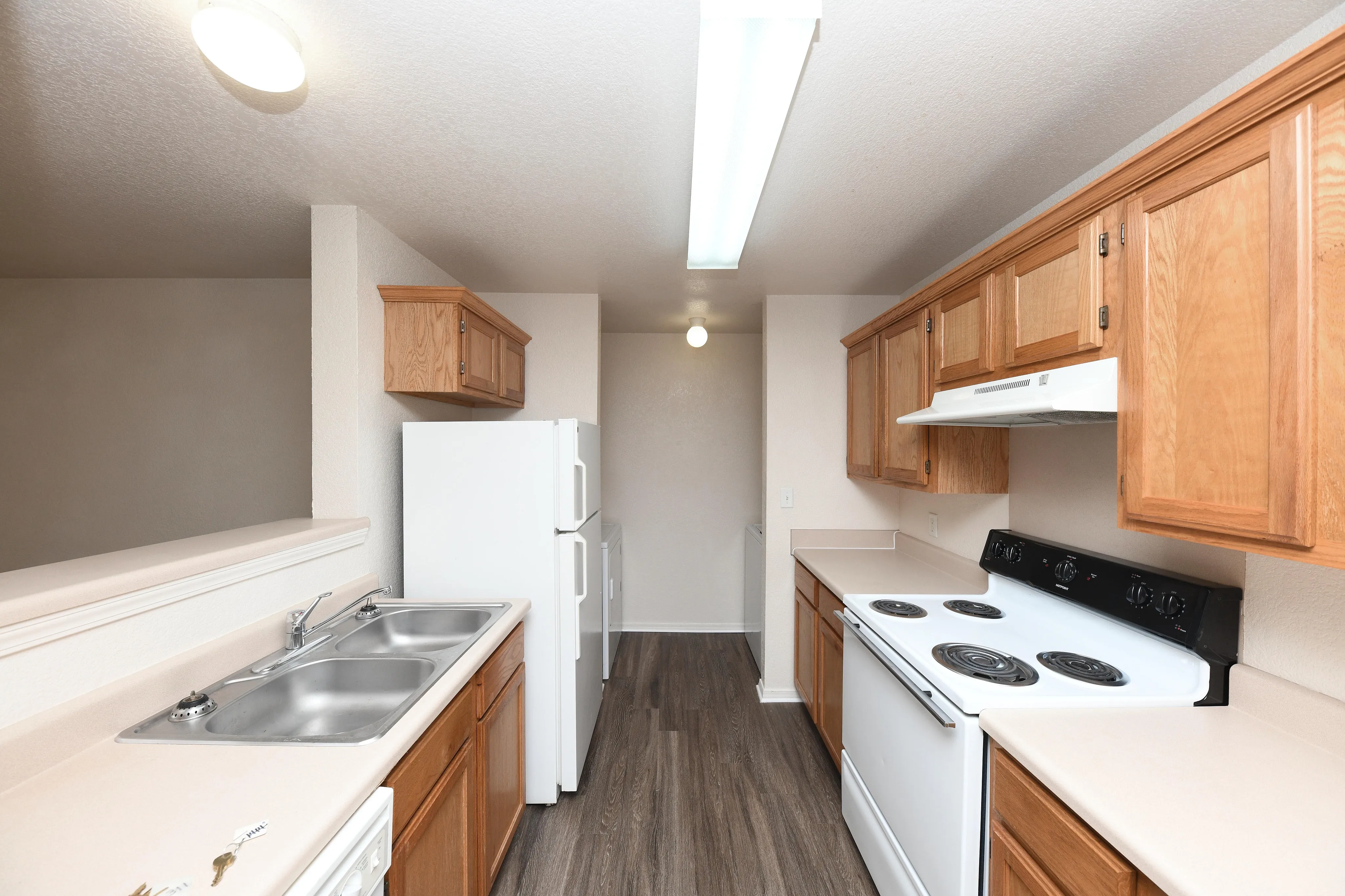 Modern kitchen with wooden cabinets, sleek countertops, and efficient appliances, offering a bright and functional cooking space.