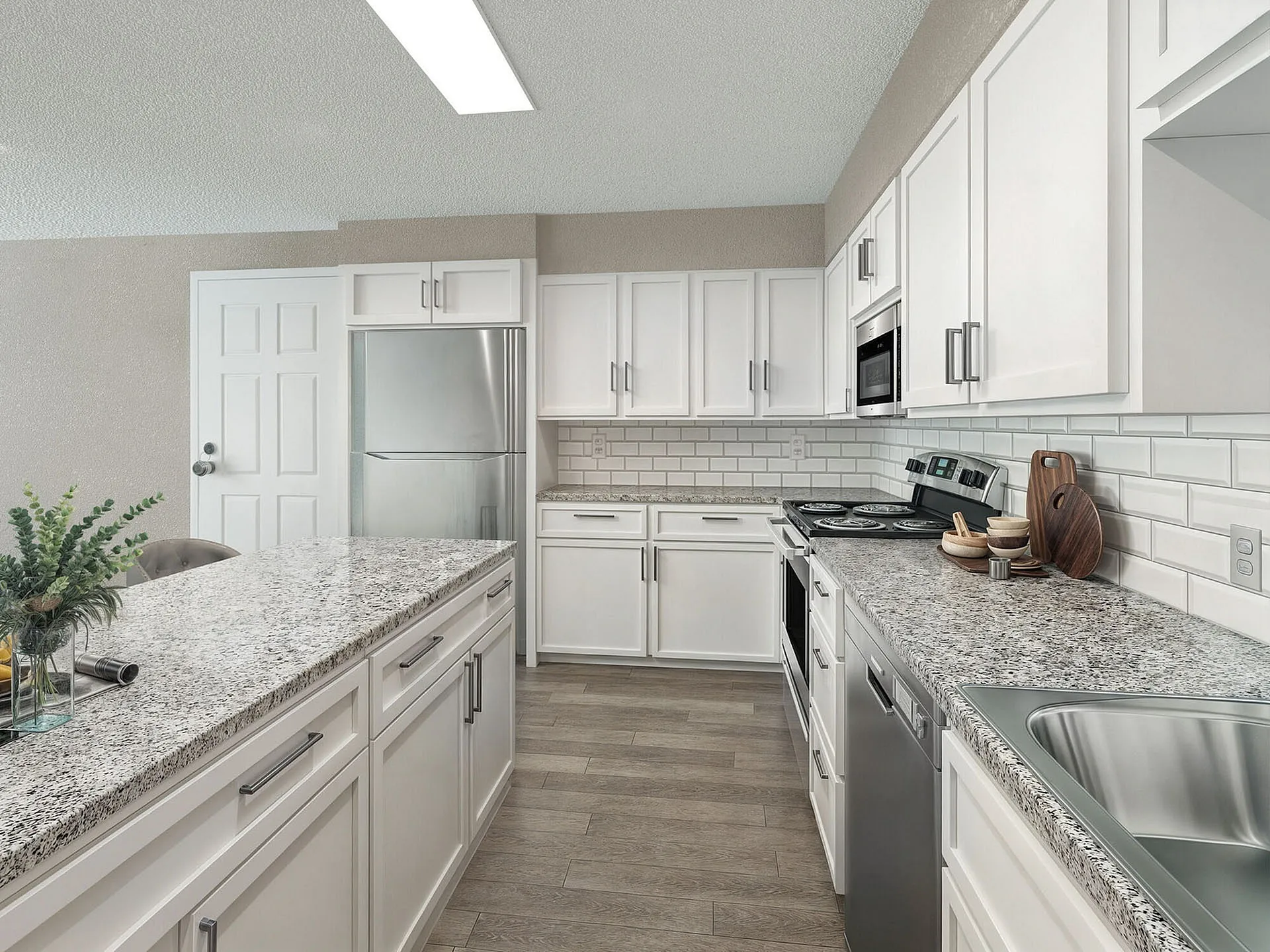 Elegant modern kitchen with sleek white cabinetry, granite countertops, and stainless steel appliances, offering a bright and spacious cooking area.
