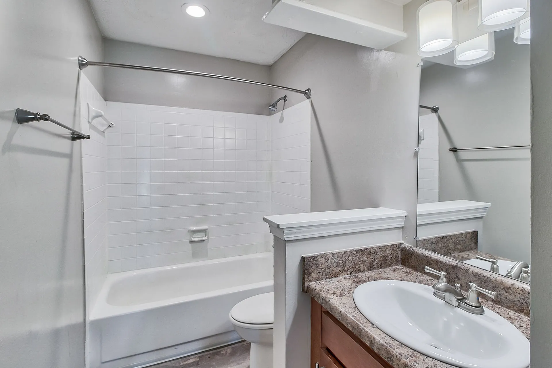 Modern bathroom with sleek fixtures, elegant countertop, and bright lighting for a refreshing experience.