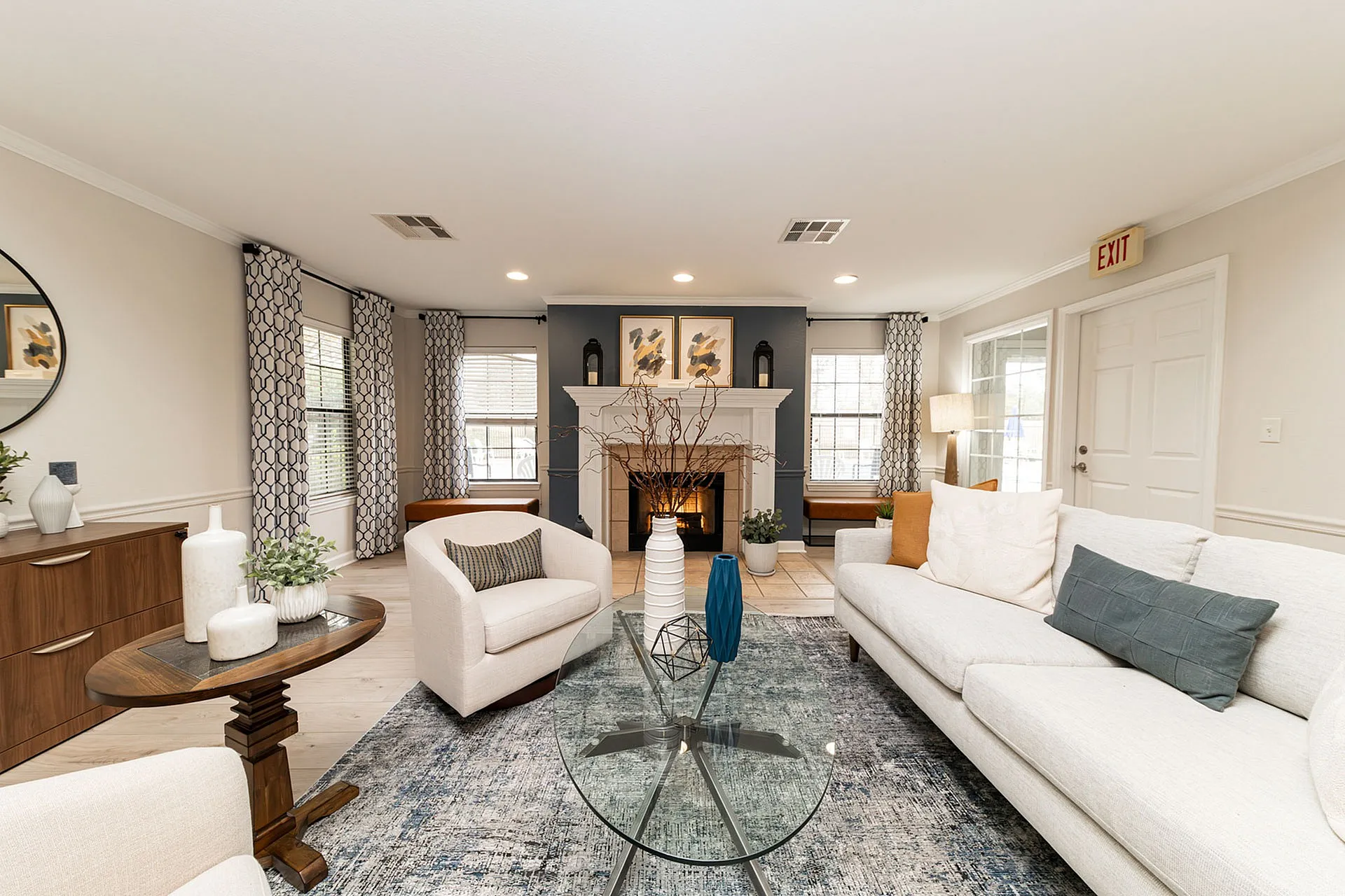 Elegant living room with plush seating, contemporary fireplace, and stylish decor in a bright open space.