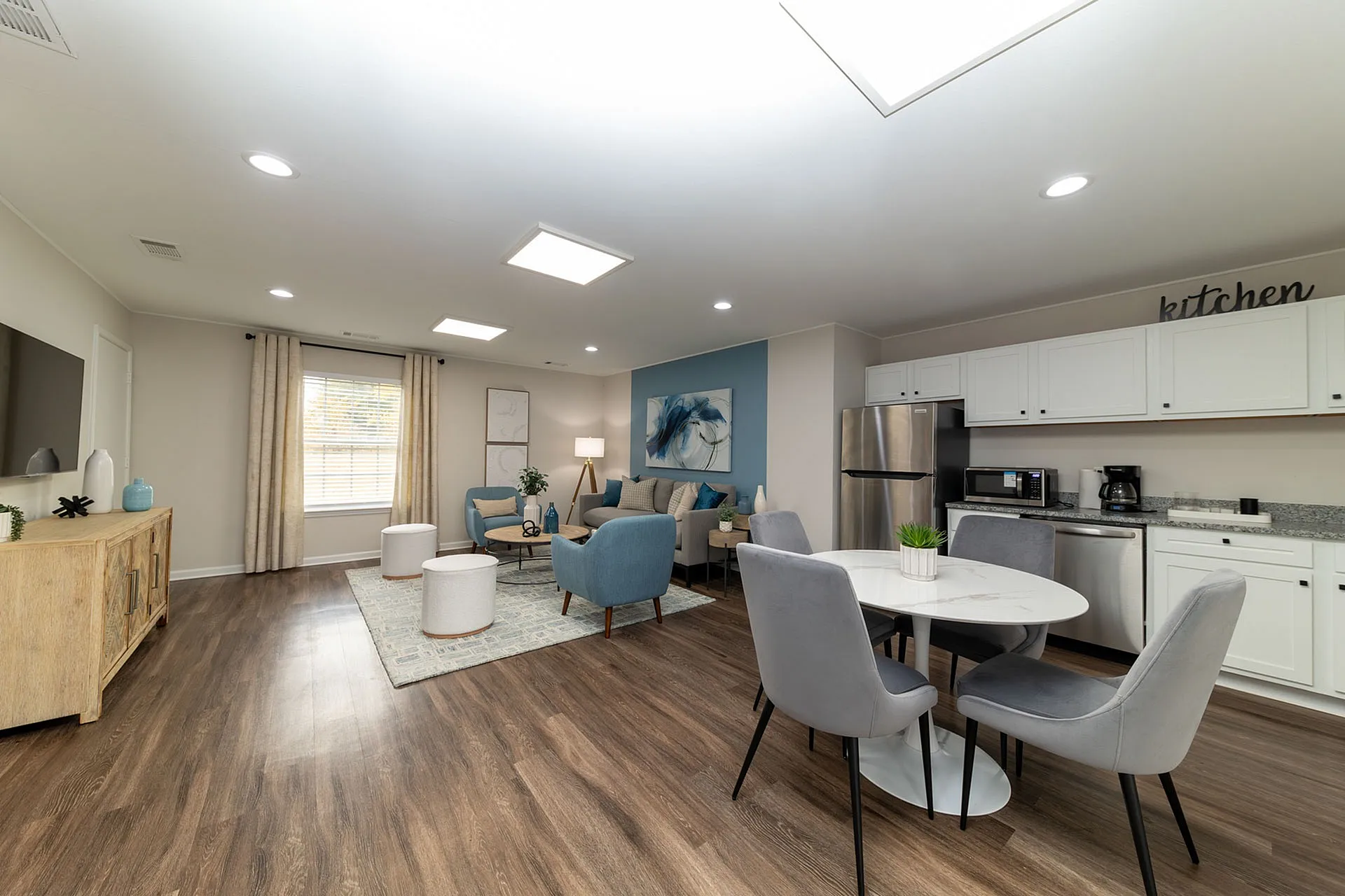 Modern living space with elegant design featuring open-concept kitchen, cozy seating area, and chic dining table in a bright, inviting atmosphere.