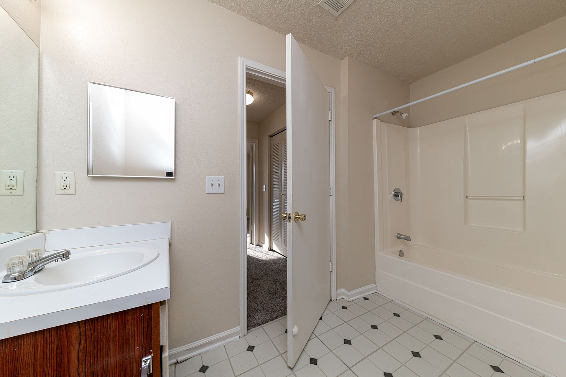 Contemporary bathroom with sleek fixtures, a modern bathtub, and ample natural light.