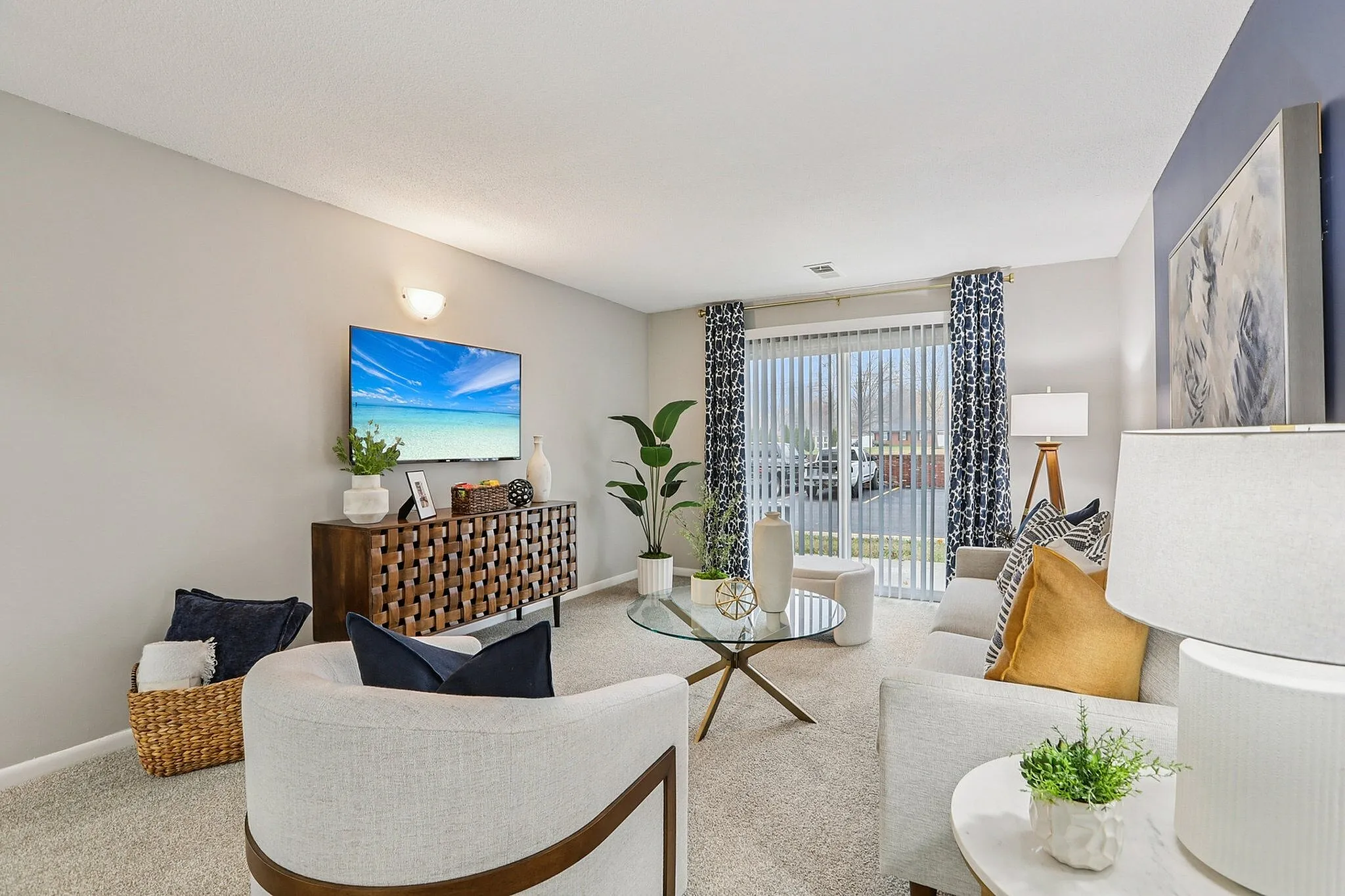Inviting living room with elegant decor, featuring plush seating, modern media console, and large windows with stylish curtains for natural light.