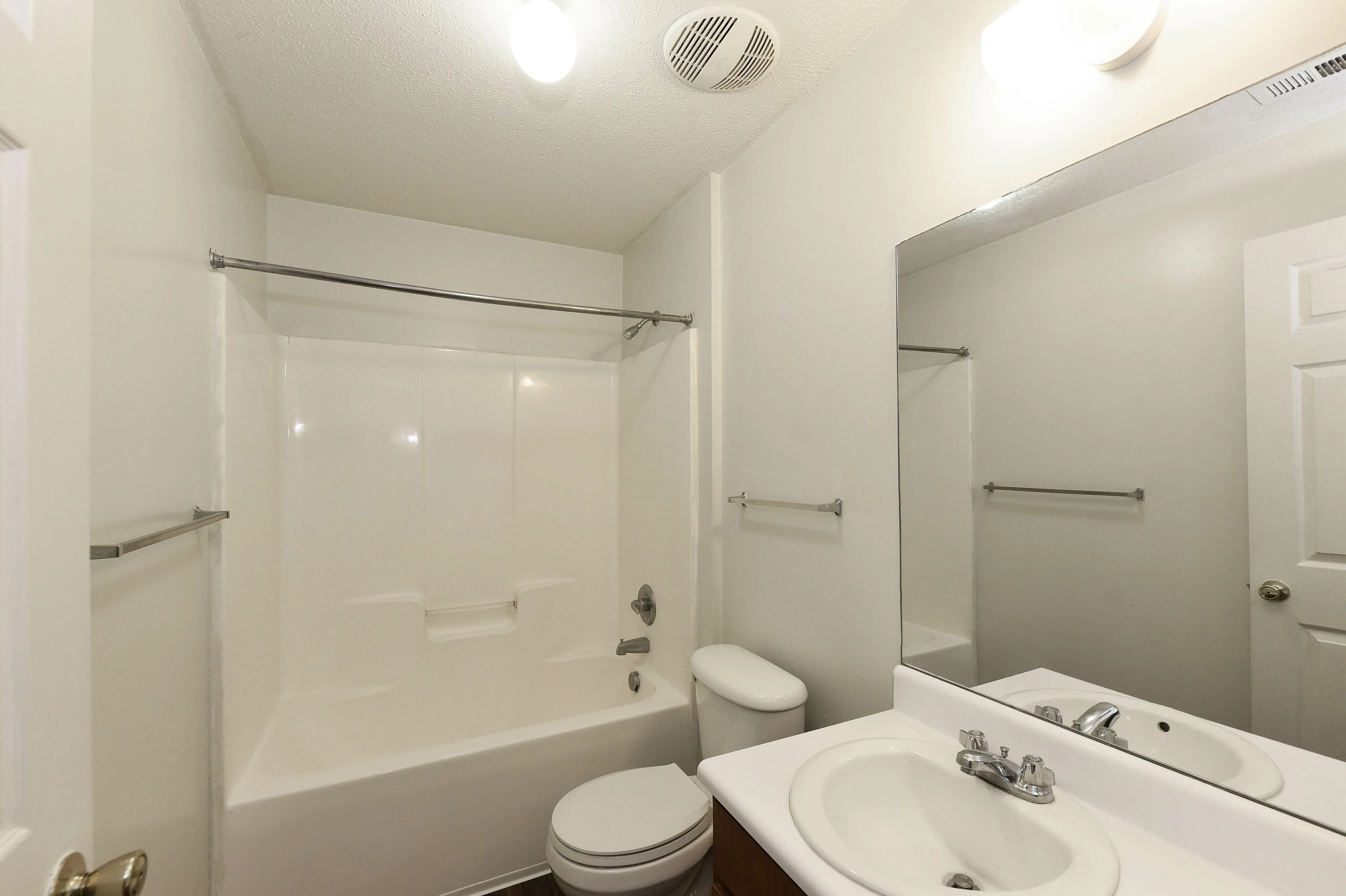 Bright and modern bathroom featuring a pristine bathtub, elegant sink, and stylish fixtures.
