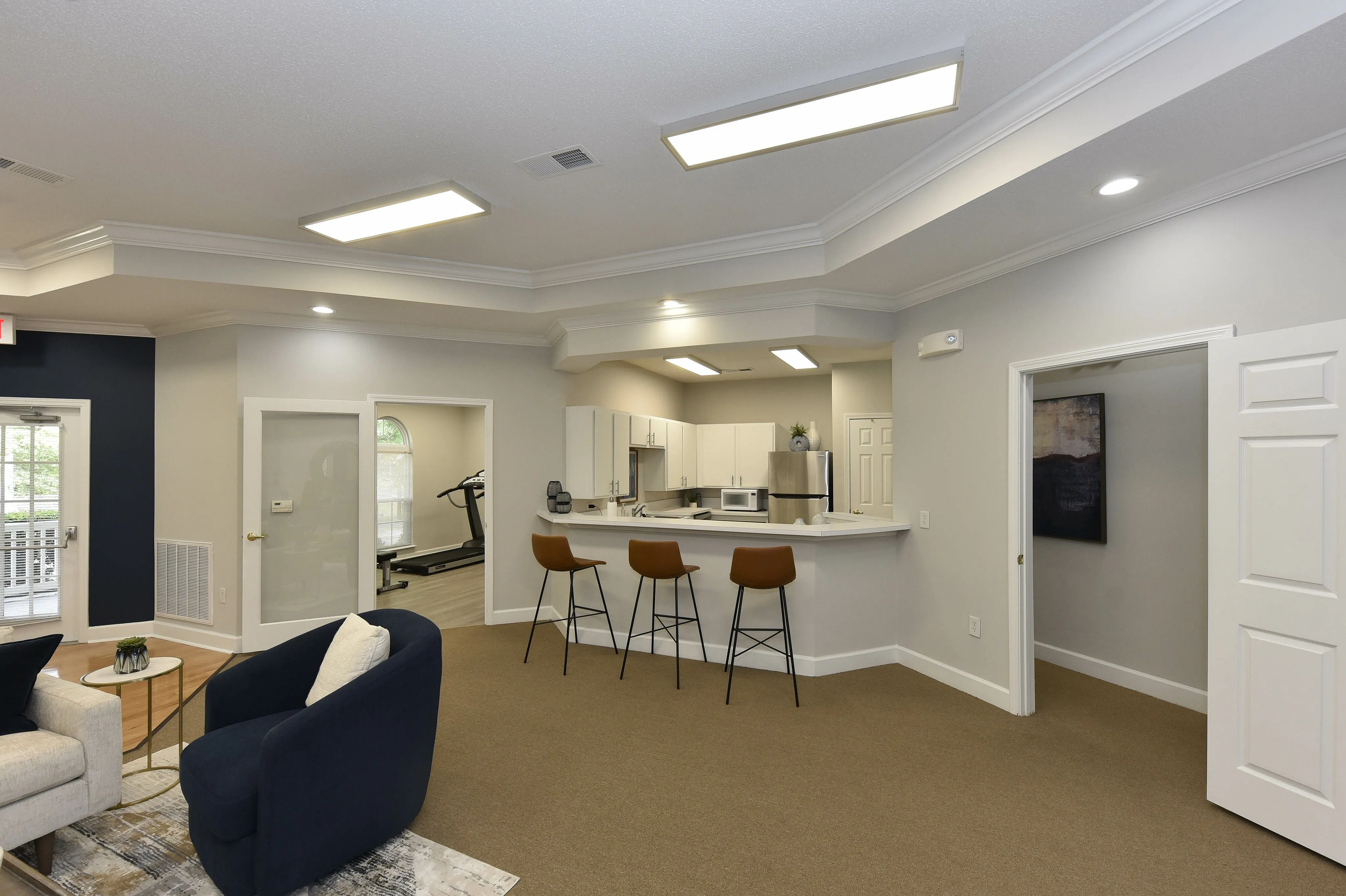 Inviting open living space with stylish bar seating and a modern kitchen, perfect for entertaining.