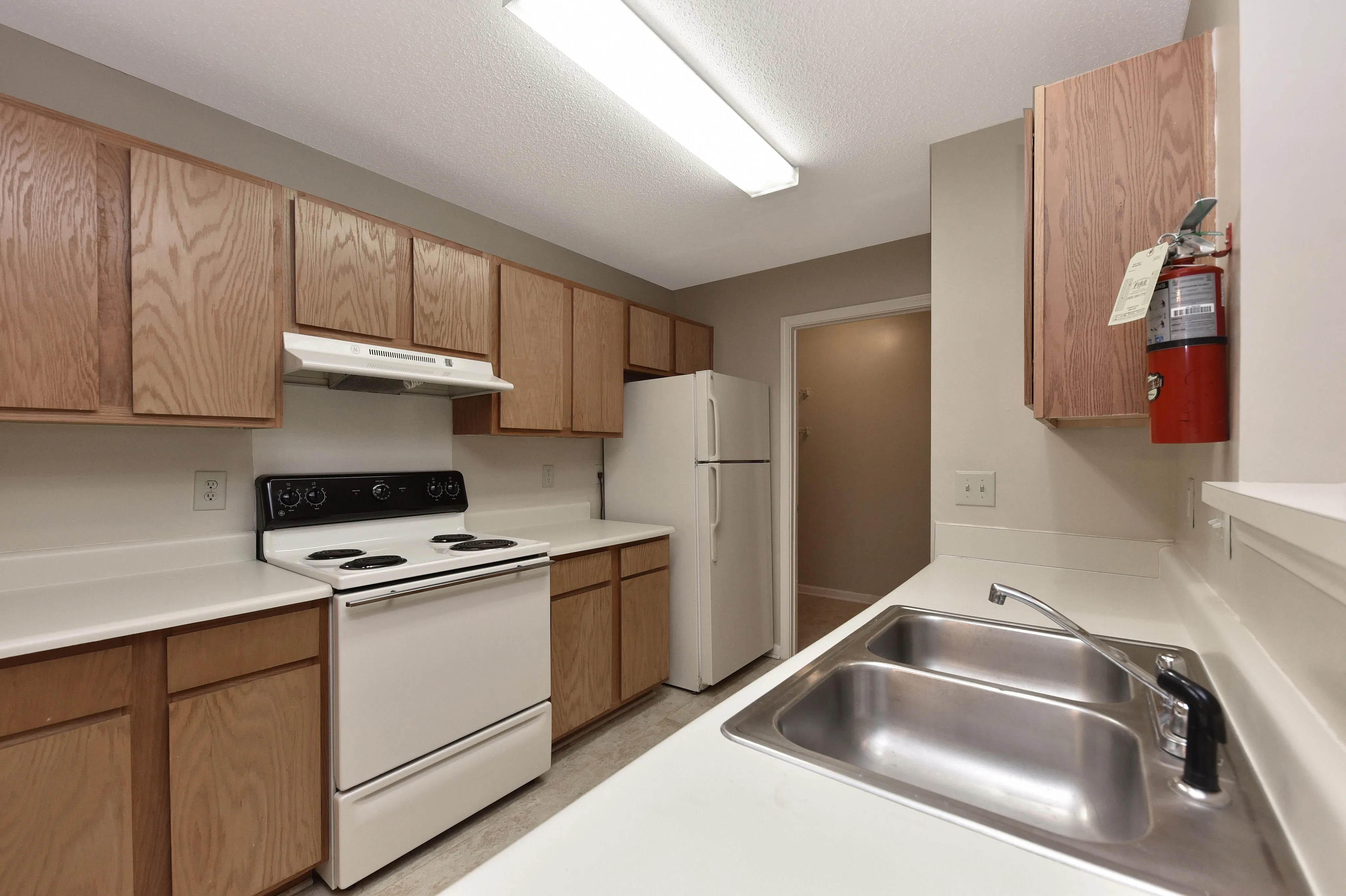 Bright and inviting kitchen featuring modern appliances, sleek countertops, and ample wooden cabinetry.