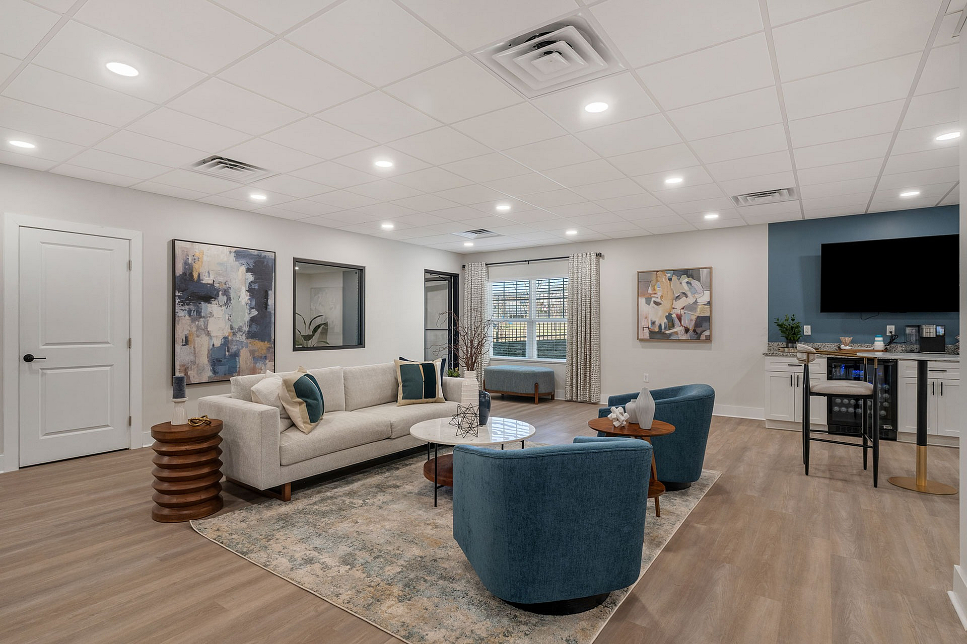 Chic and inviting living room with modern decor, featuring a plush sofa, elegant armchairs, and a cozy entertainment area.