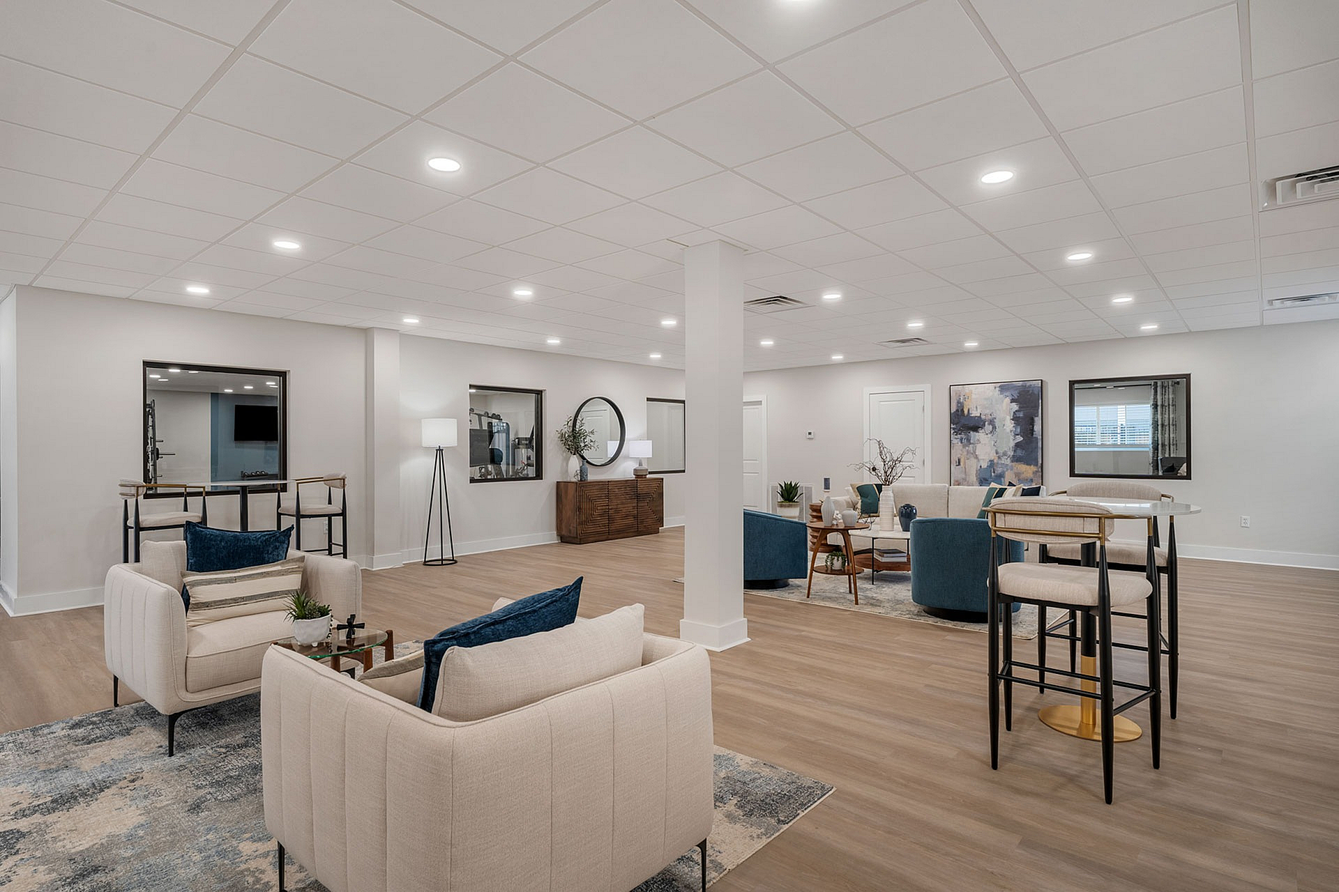 Modern communal lounge featuring elegant seating, sophisticated decor, and ambient lighting, perfect for relaxation and social gatherings.