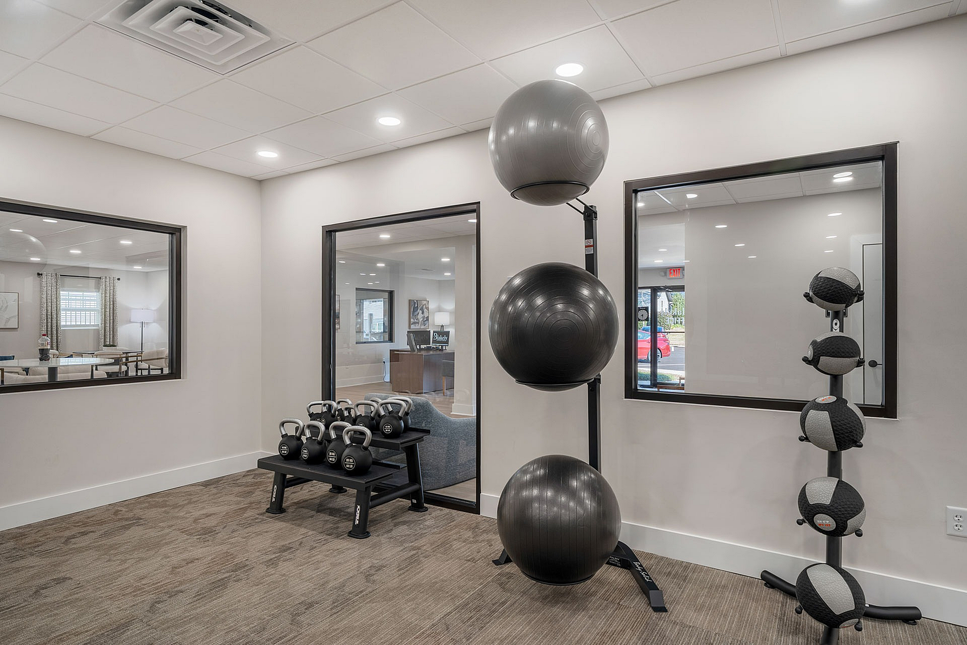 Modern fitness area featuring sleek kettlebells, exercise balls, and stylish design, perfect for an invigorating workout session.