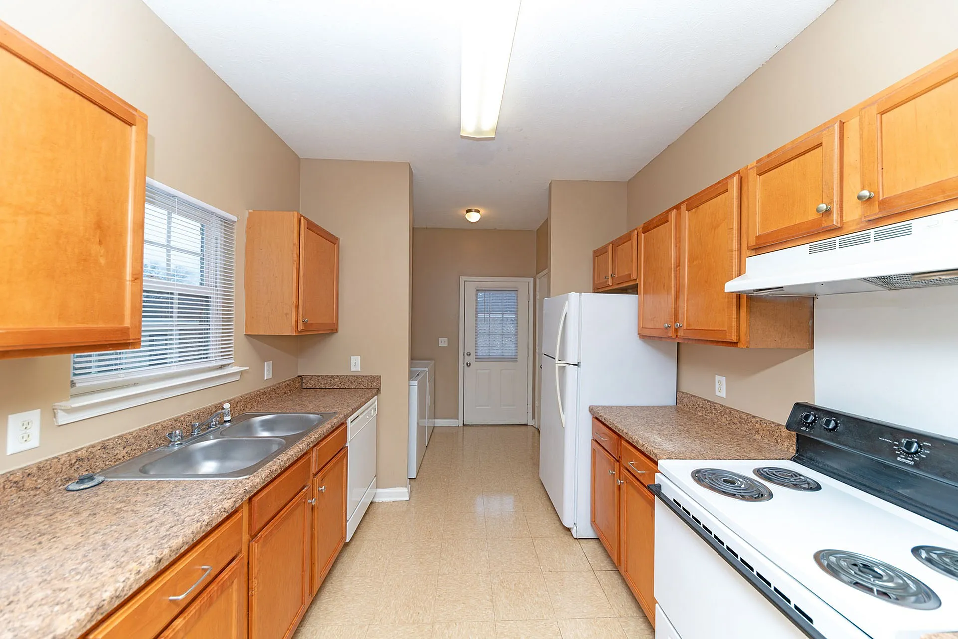 Inviting kitchen with bright cabinets, sleek countertops, and modern appliances, ideal for culinary enthusiasts.