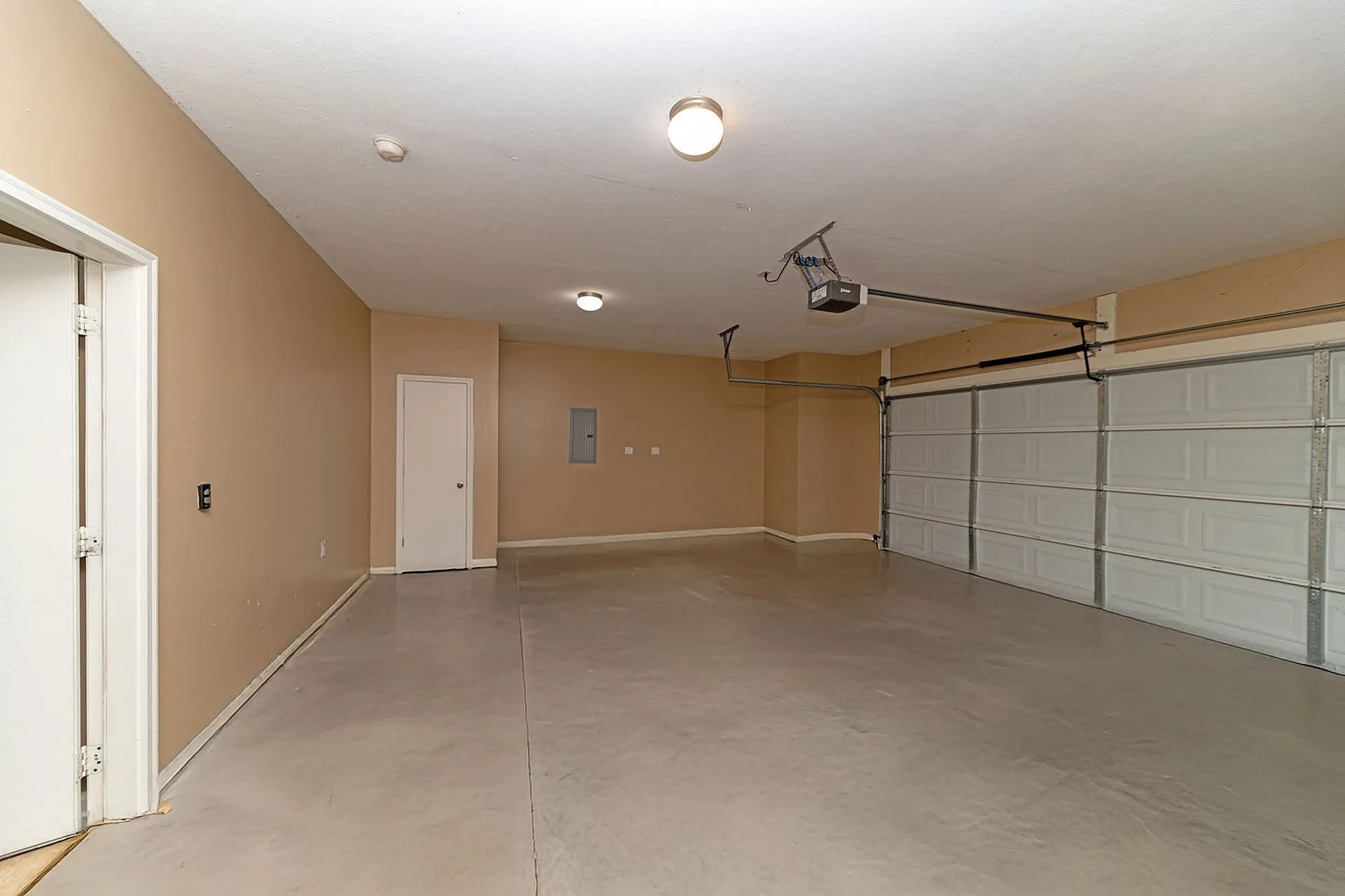 Spacious two-car garage with modern lighting and ample storage potential, perfect for organizing tools and maximizing utility.