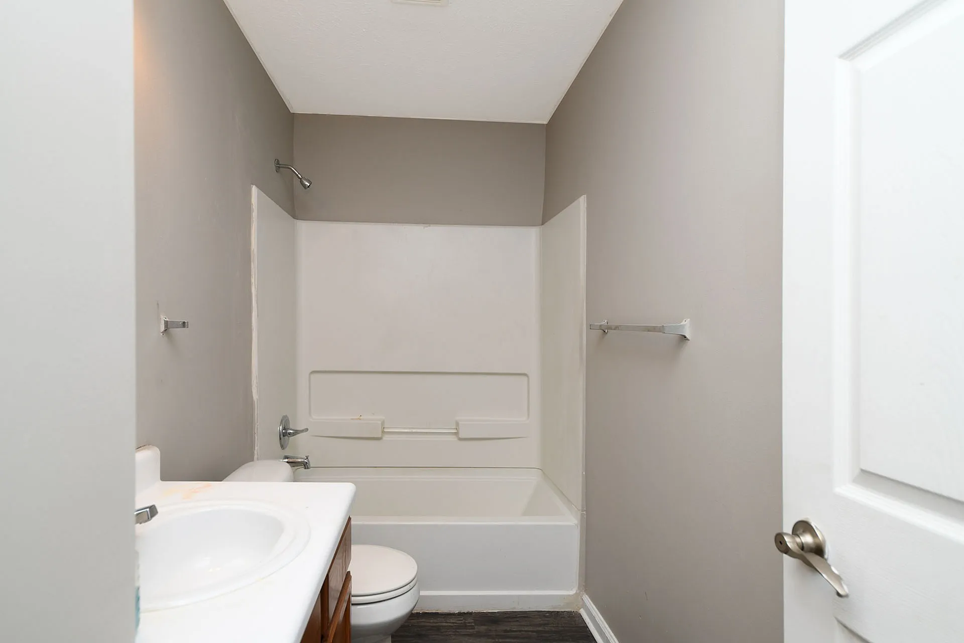 Modern bathroom with clean white fixtures, sleek bathtub, and contemporary design.