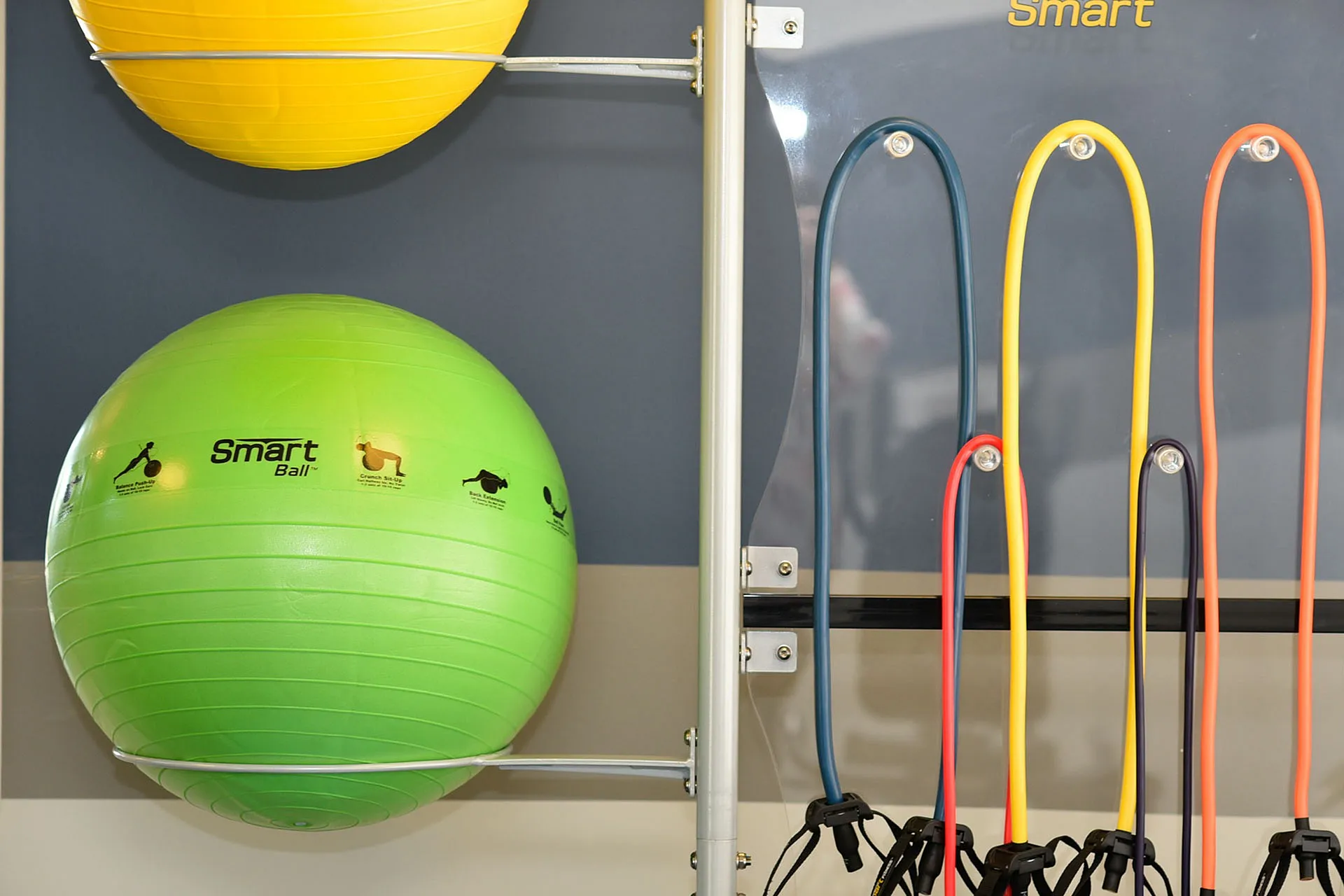 Vibrant home gym setup with colorful exercise balls and resistance bands, perfect for dynamic workouts.