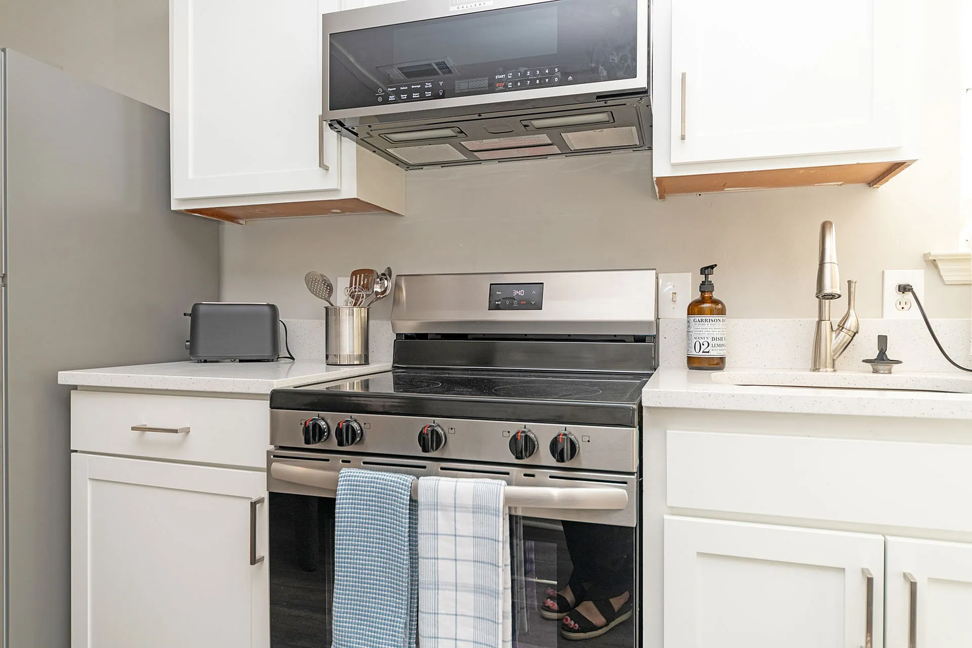 Modern kitchen with sleek stainless steel appliances, elegant white cabinetry, and stylish countertops.