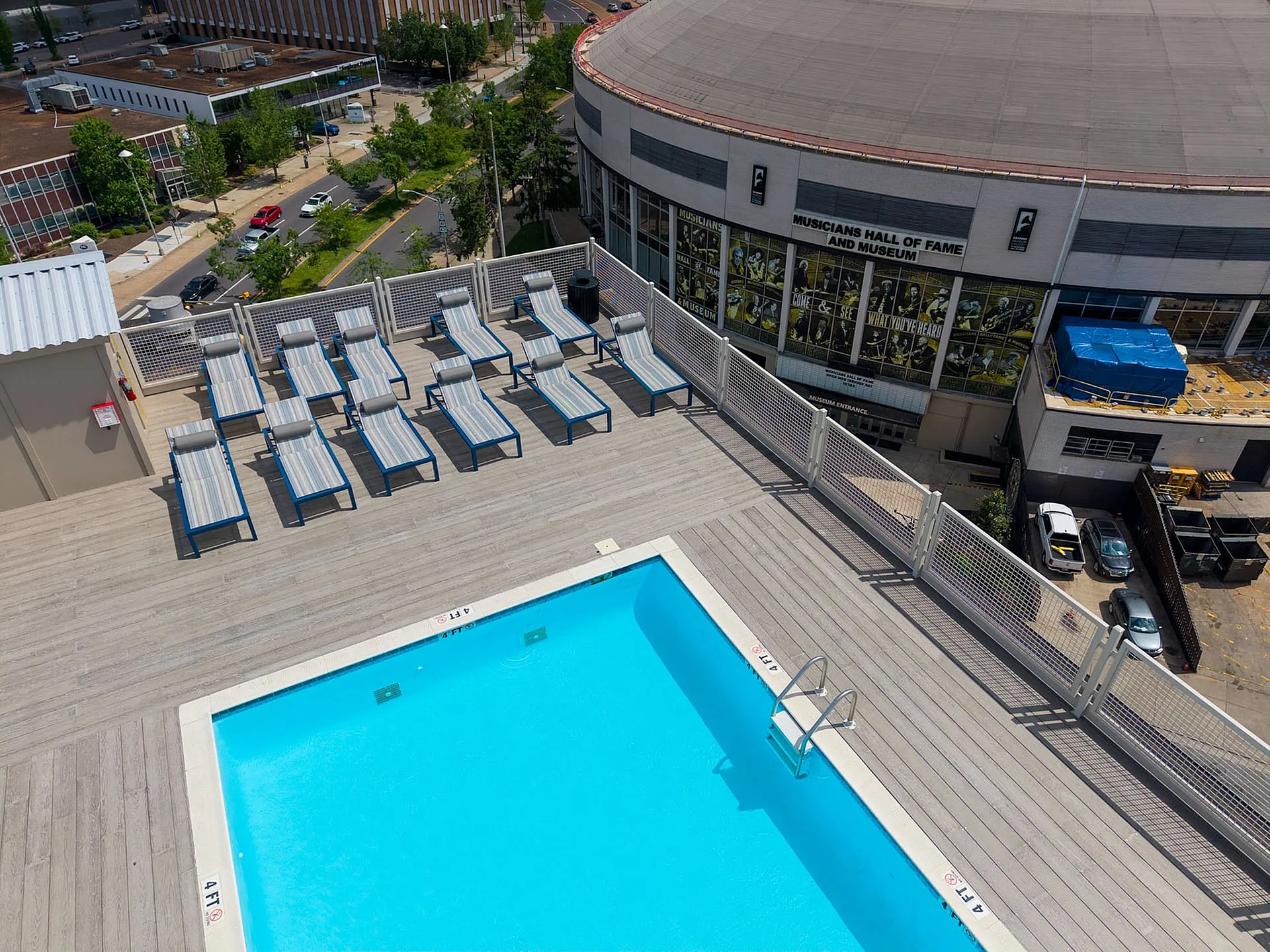 Inviting rooftop pool with chic sun loungers offering stunning cityscape views next to the Musicians Hall of Fame.