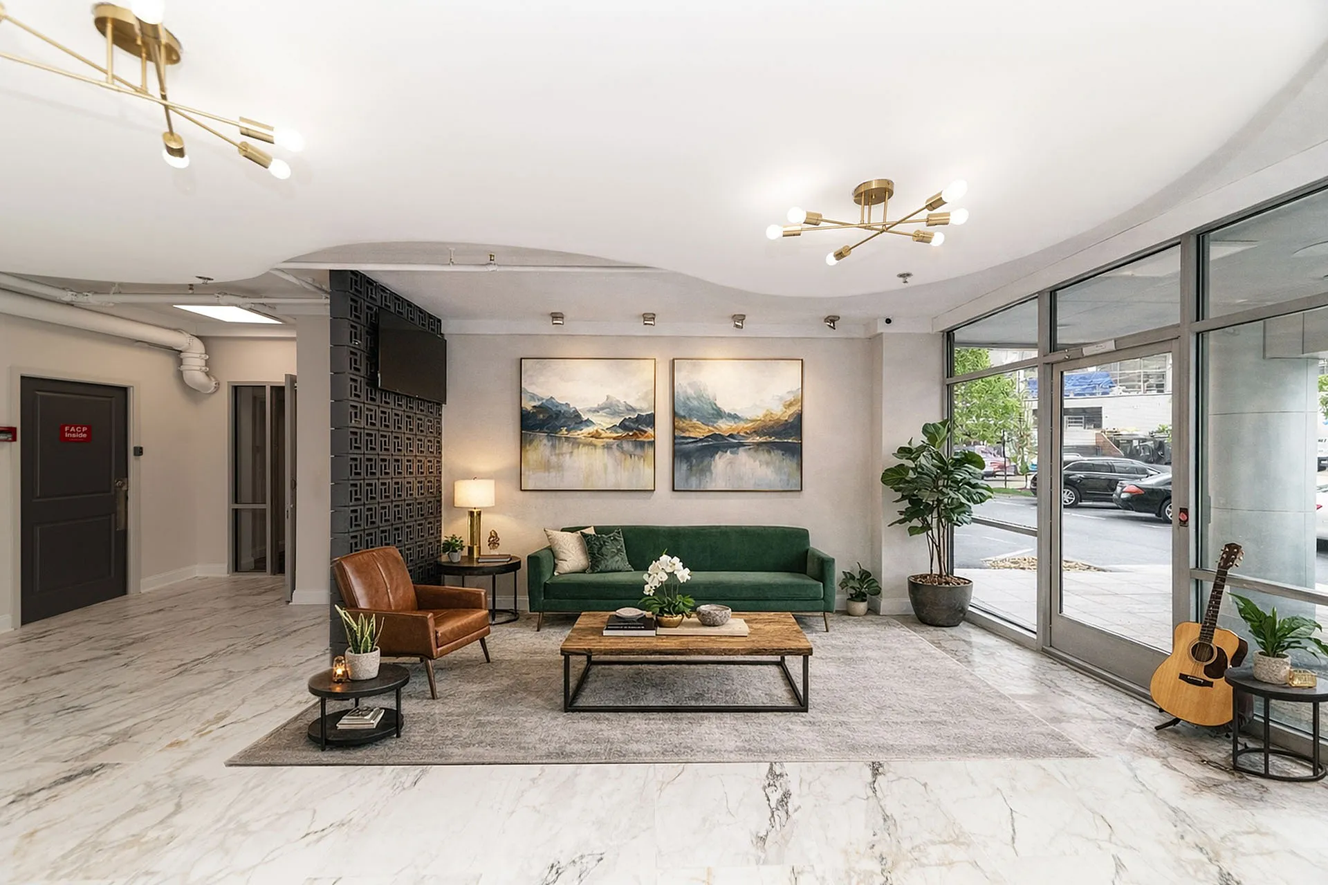 Elegant apartment lobby featuring modern decor with marble flooring, stylish green sofa, and artistic wall paintings creating a welcoming atmosphere.