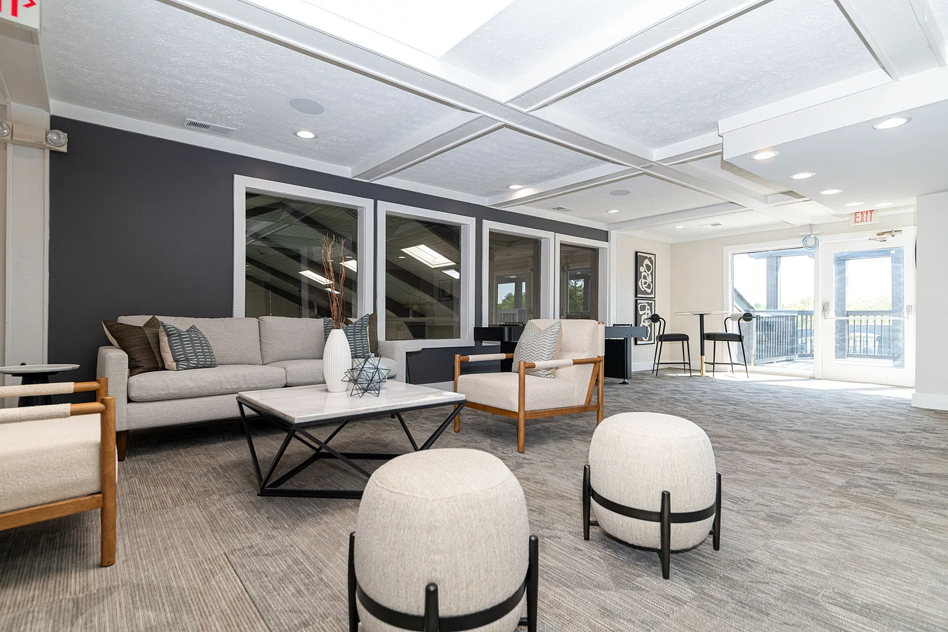 Bright and spacious modern lounge area with plush seating, elegant decor, and large windows offering abundant natural light.