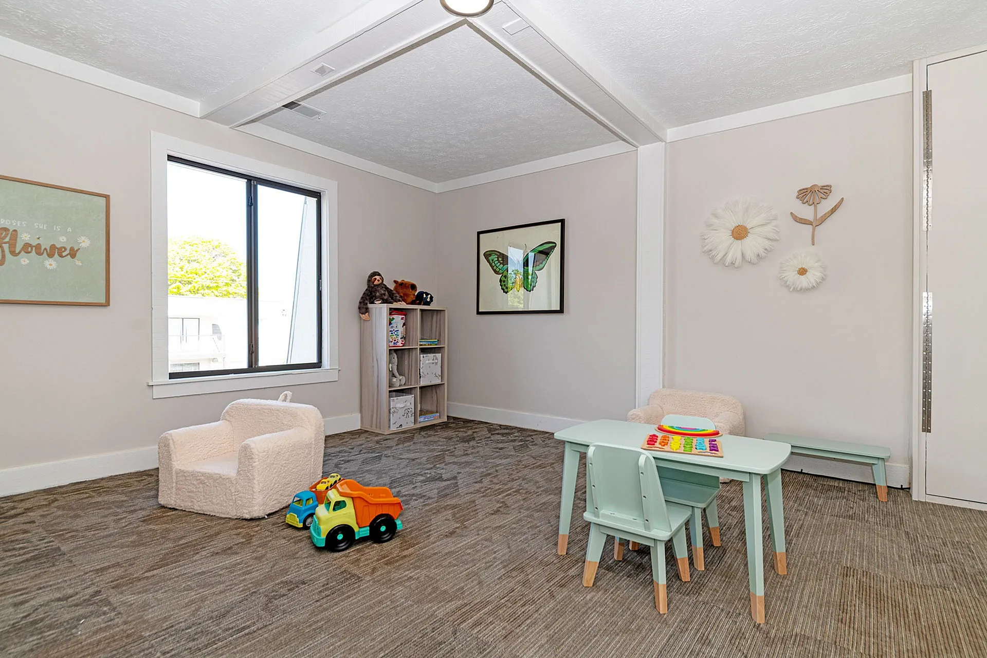 Bright and inviting children's playroom featuring soft seating, a colorful activity table, and playful decor.