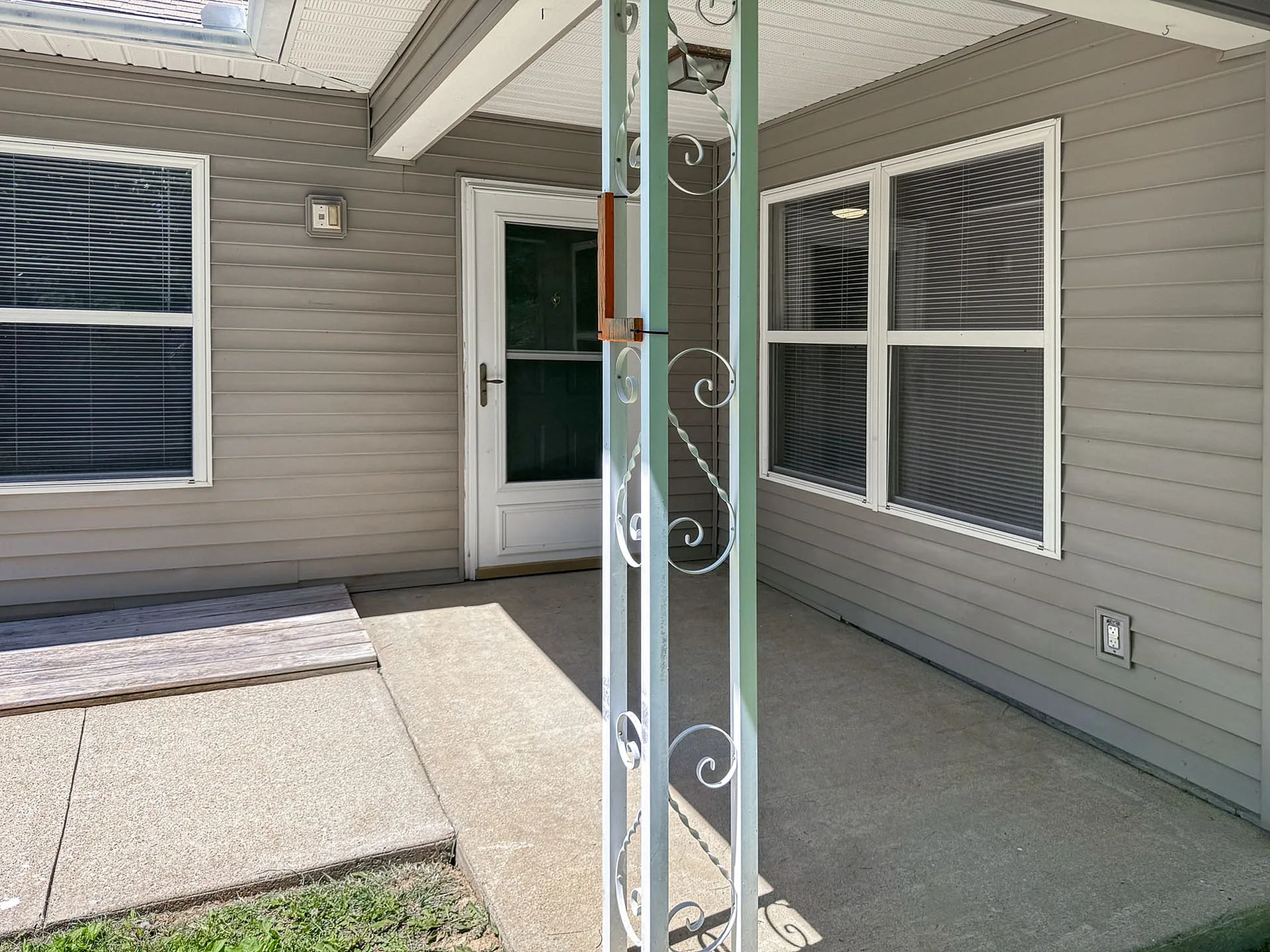 Inviting covered patio with charming decorative post, perfect for relaxing outdoor moments.