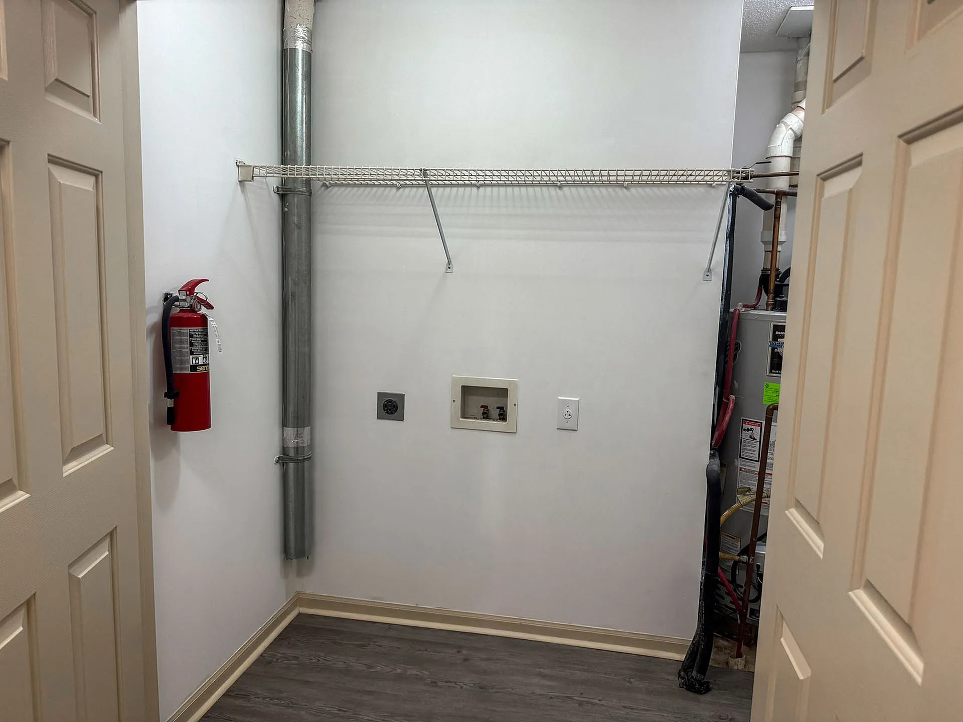 Modern utility room featuring ample storage space, sleek piping fixtures, and essential safety equipment.
