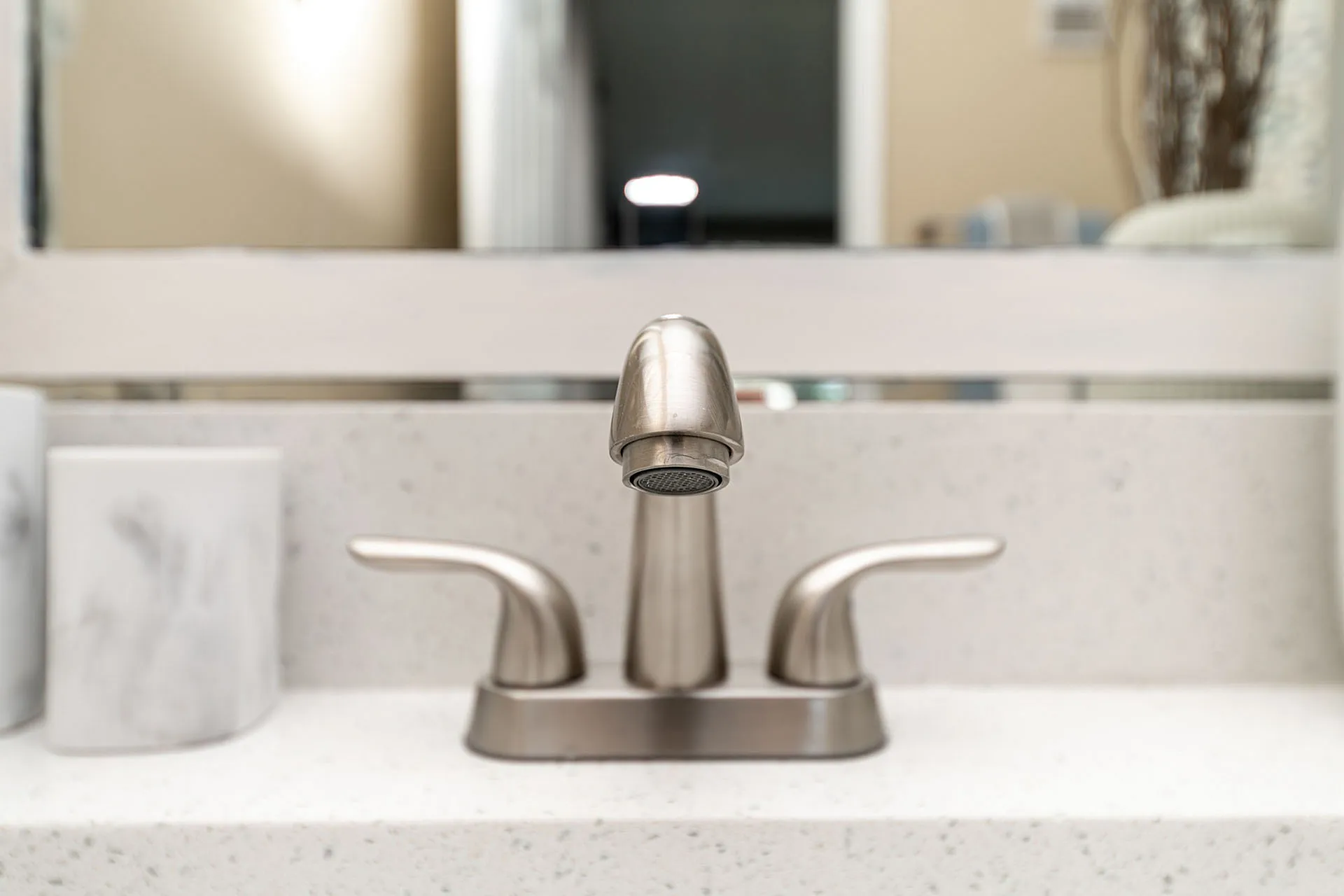 Elegant bathroom sink featuring a sleek stainless steel faucet and polished countertop.
