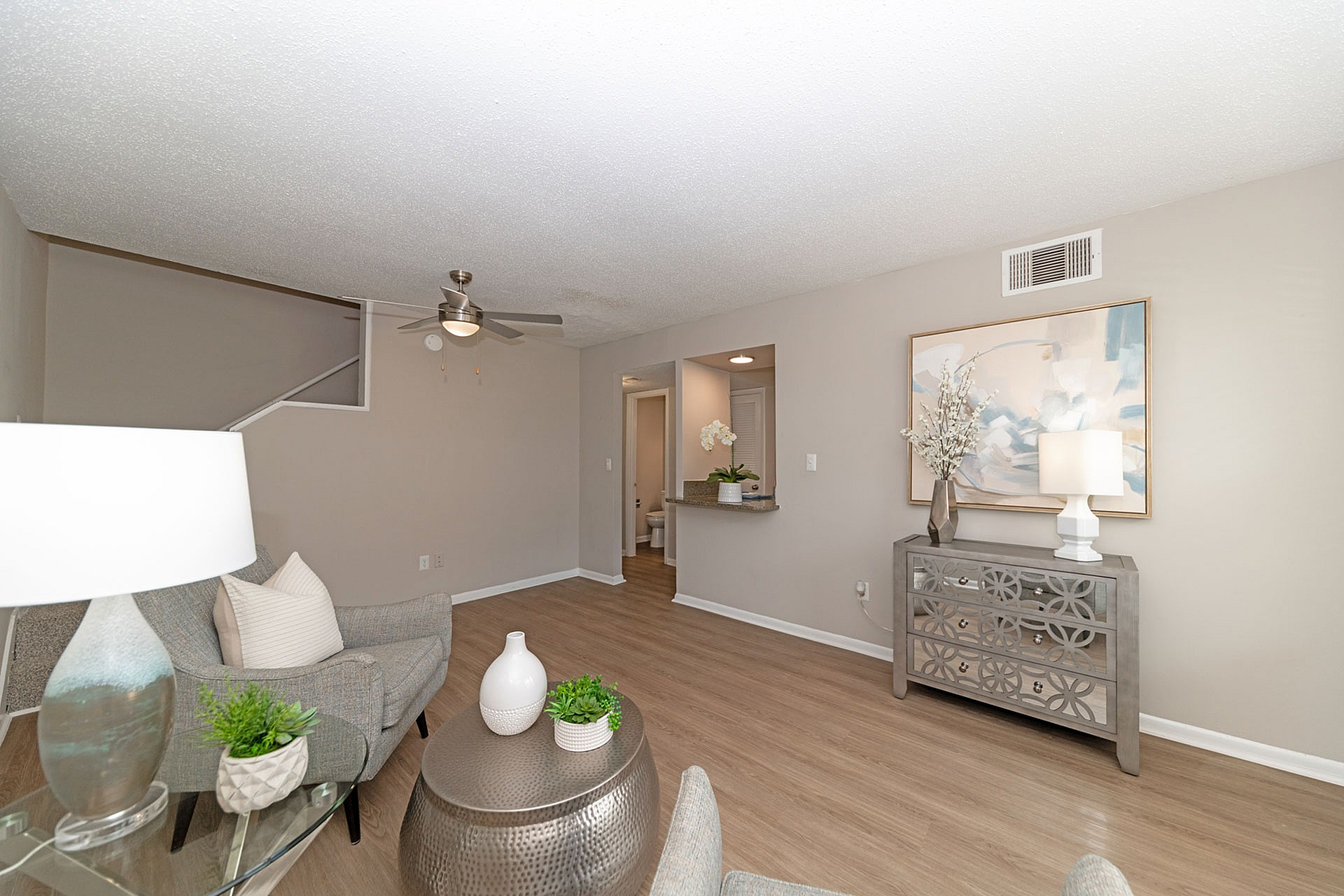 Inviting living room featuring elegant decor, hardwood floors, and modern ceiling fan.